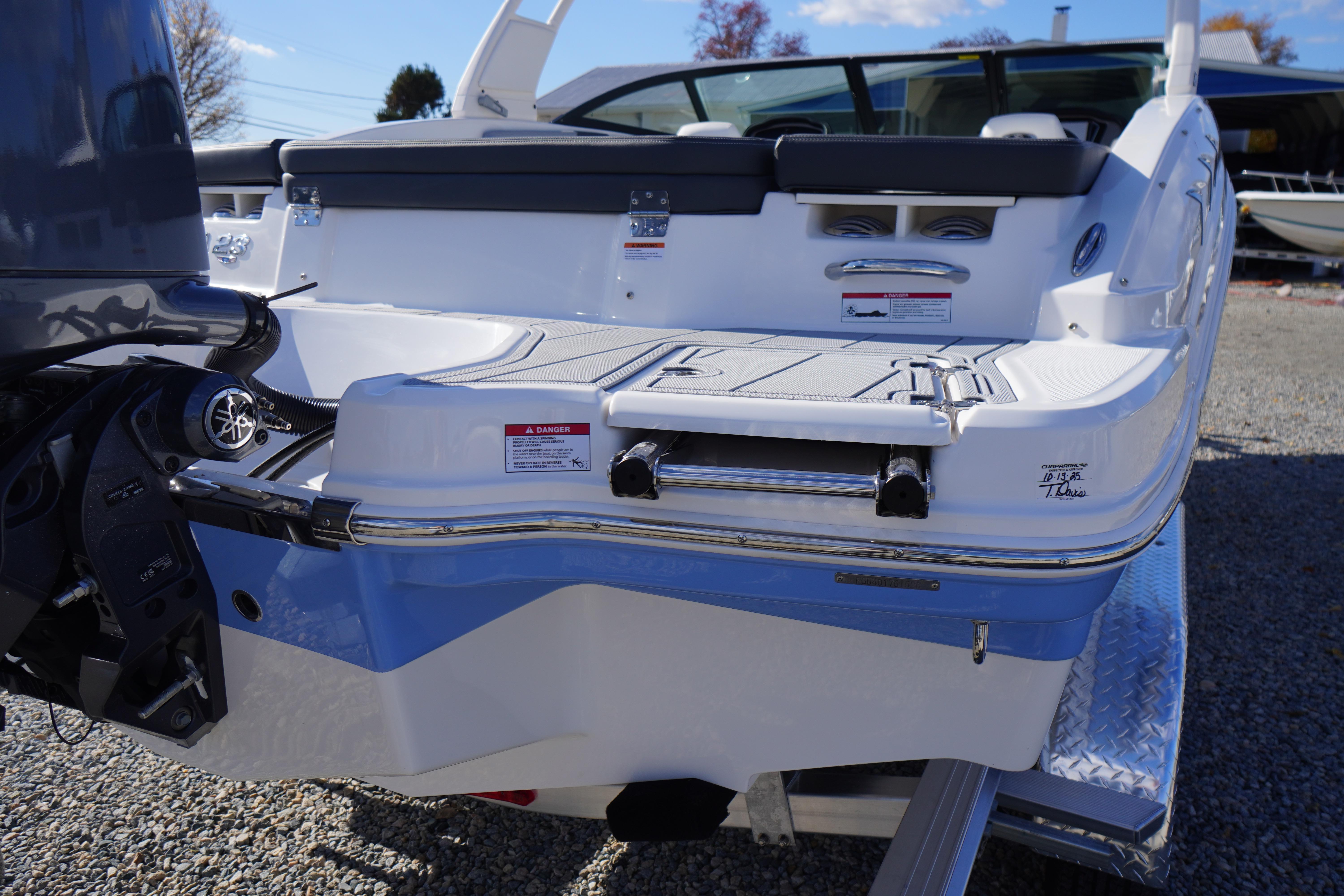 2026 Chaparral 23 SSi OB boat rear view with outboard motor and swim platform.