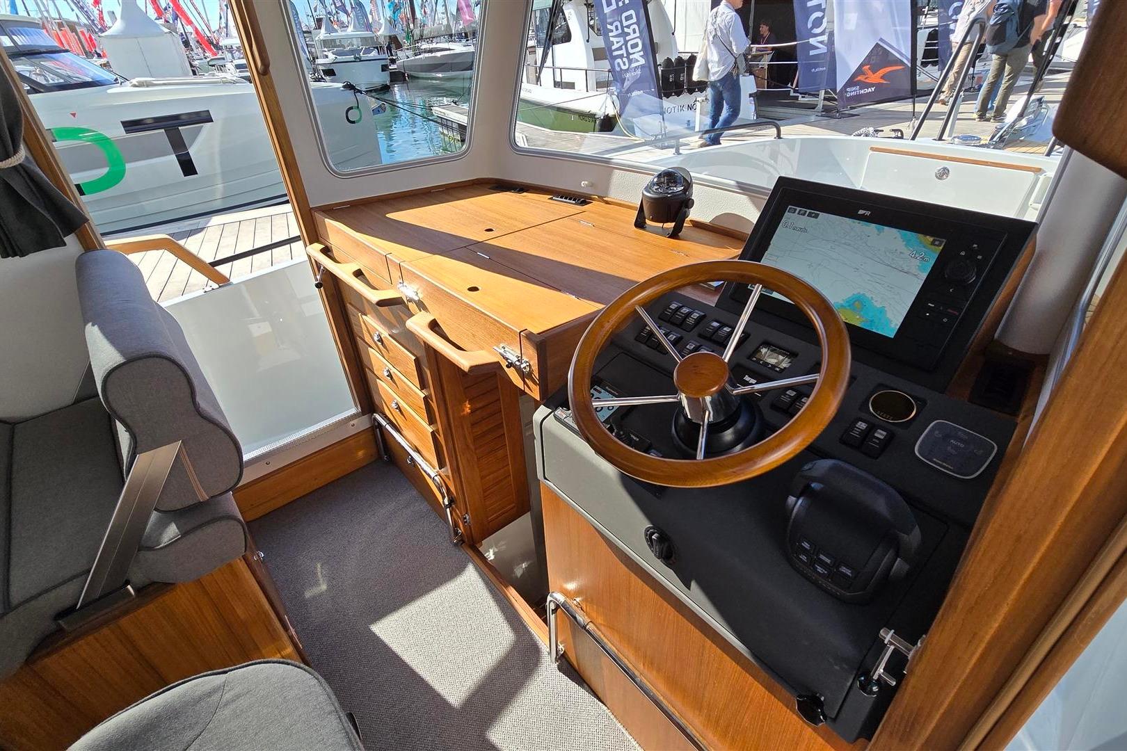 Interior of 2026 Targa 27.2 boat with modern navigation system and wooden dashboard.