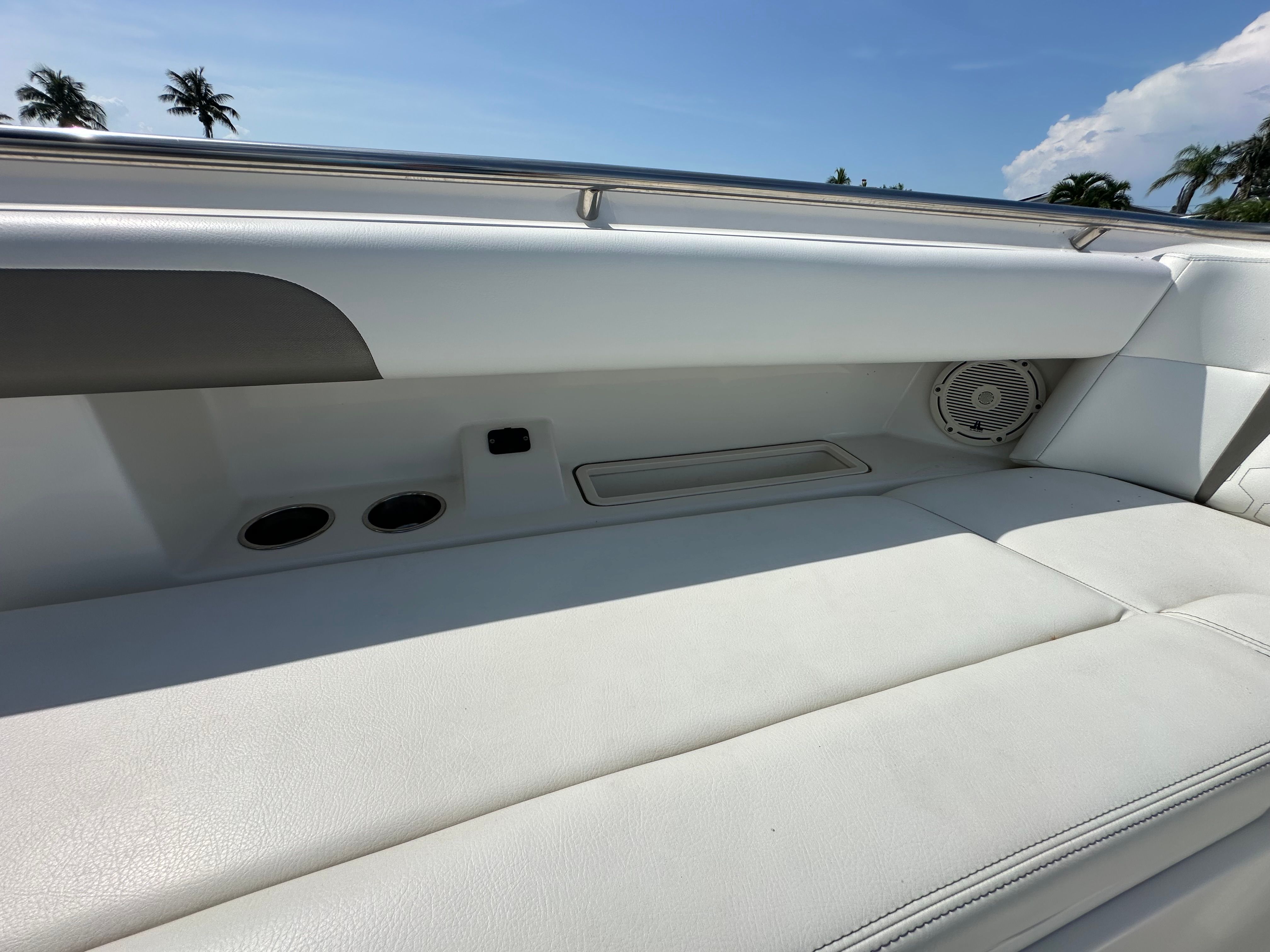 The 2020 World Cat 280 CC-X features a white cushioned bench with a speaker and cup holders.