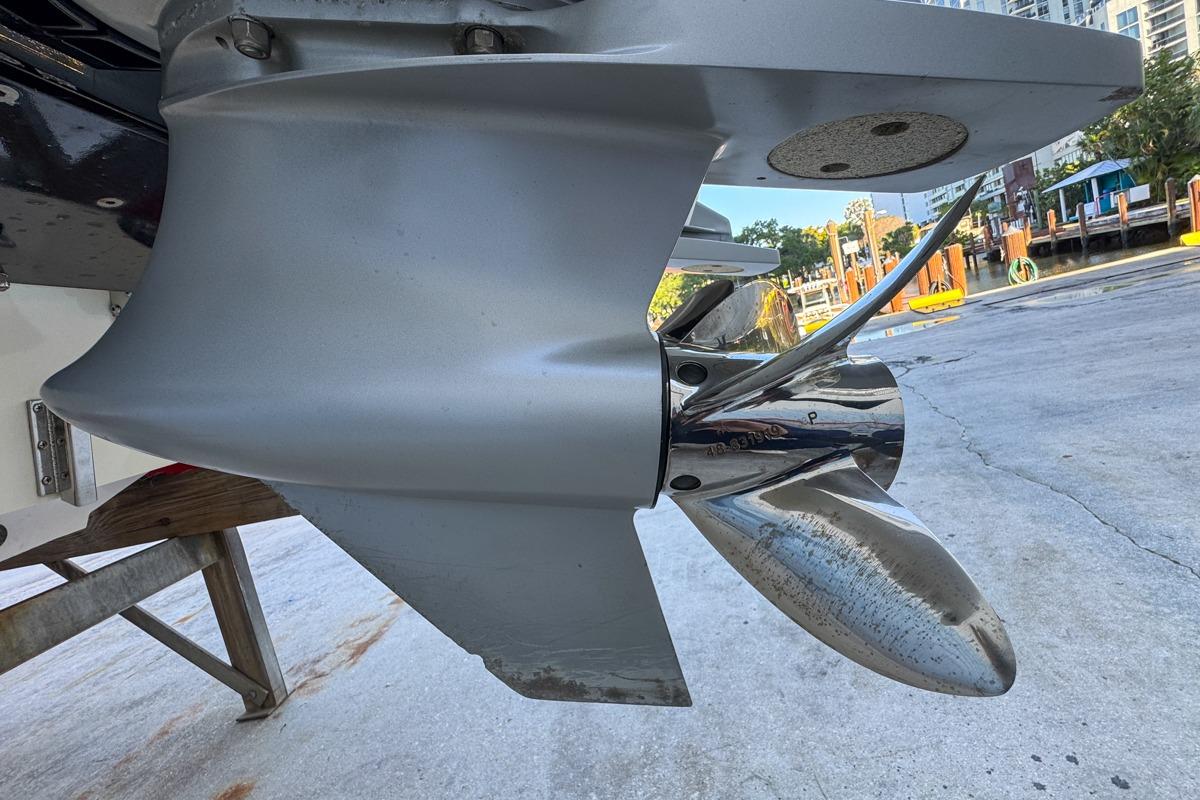 Close-up of a 2022 Velocity 290sc boat propeller on a dock.