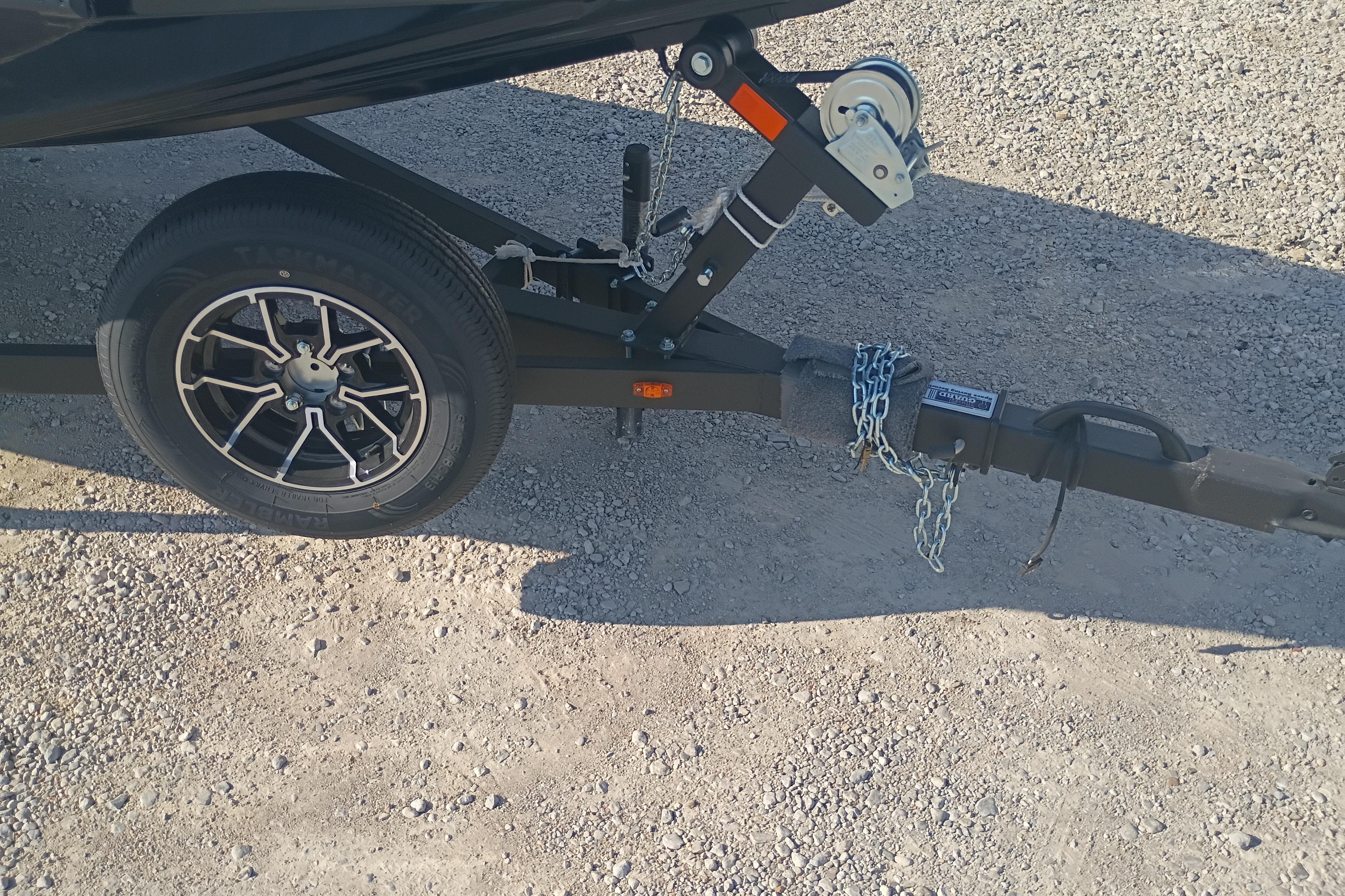 Trailer hitch and wheel of 2026 G3 1810SE on gravel surface.