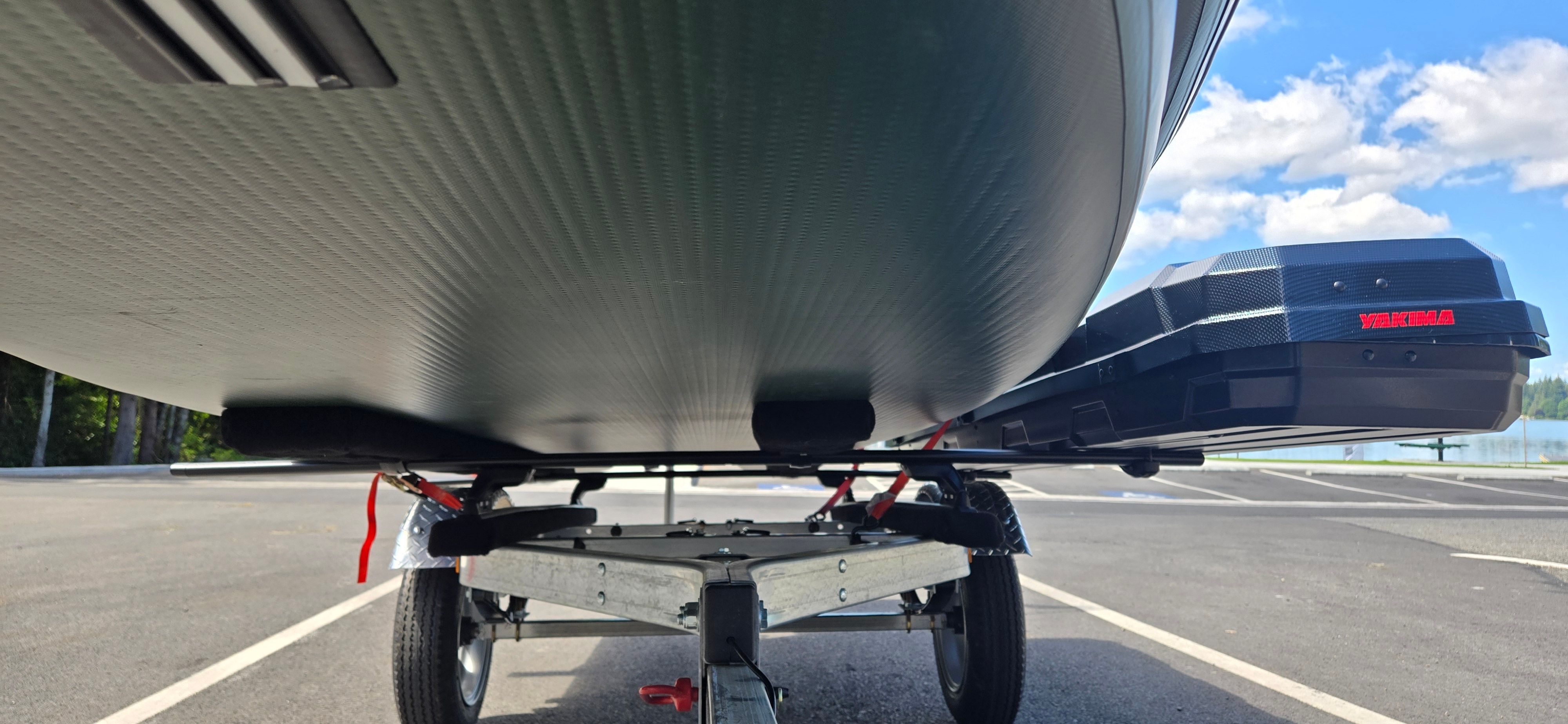 Underside view of a Sea Eagle FSK16 boat on a trailer, with blue sky in the background.