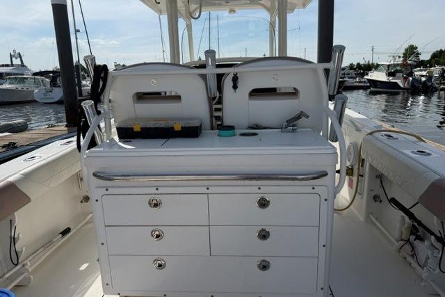 2014 Edgewater 318CC boat interior with storage drawers at a marina.