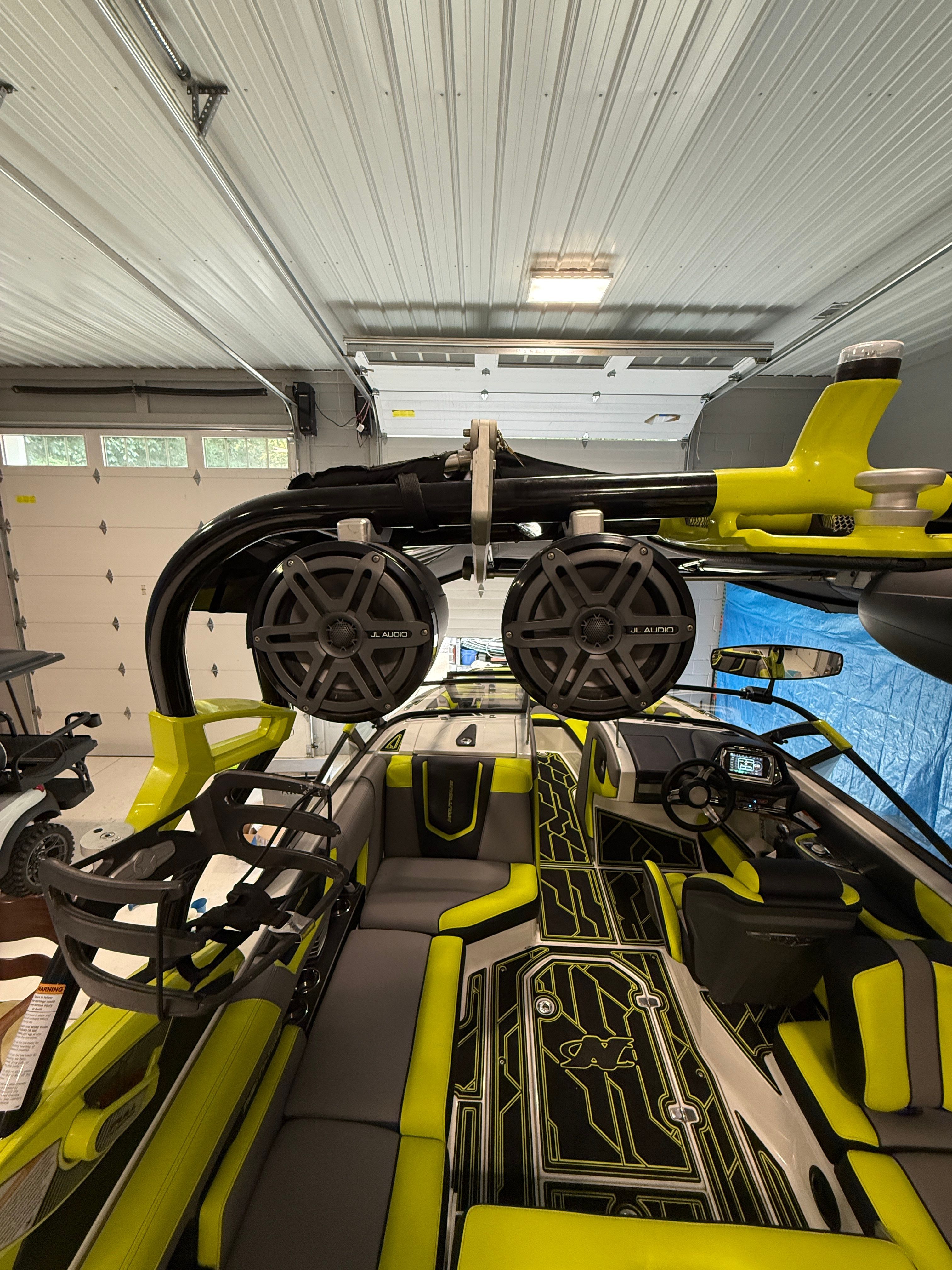 Interior of a 2016 Nautique Super Air Nautique G23 with bright yellow accents and speakers.
