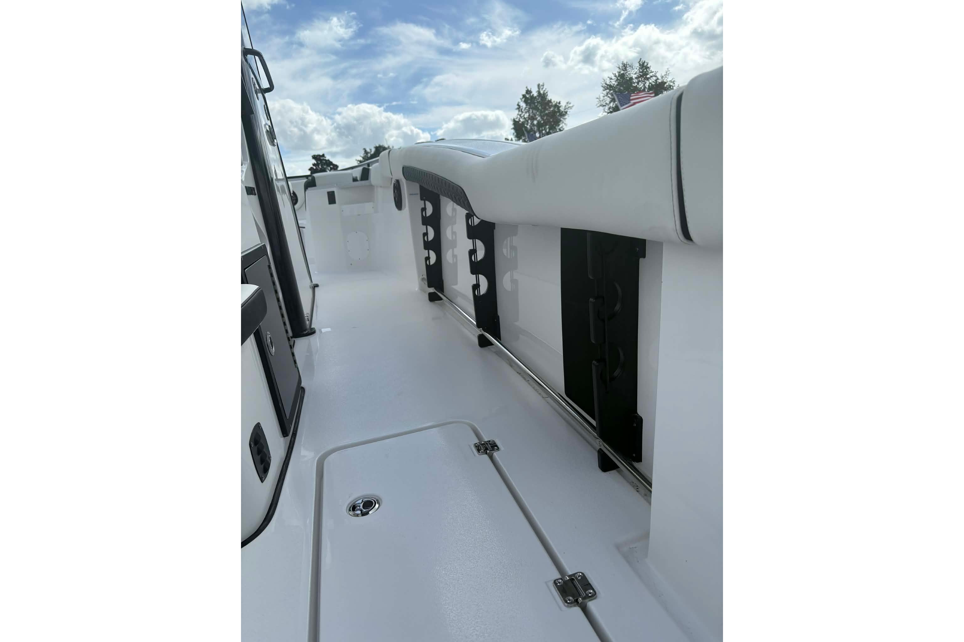 2026 Tidewater 282 CC Adventure boat deck with rod holders and storage compartments.