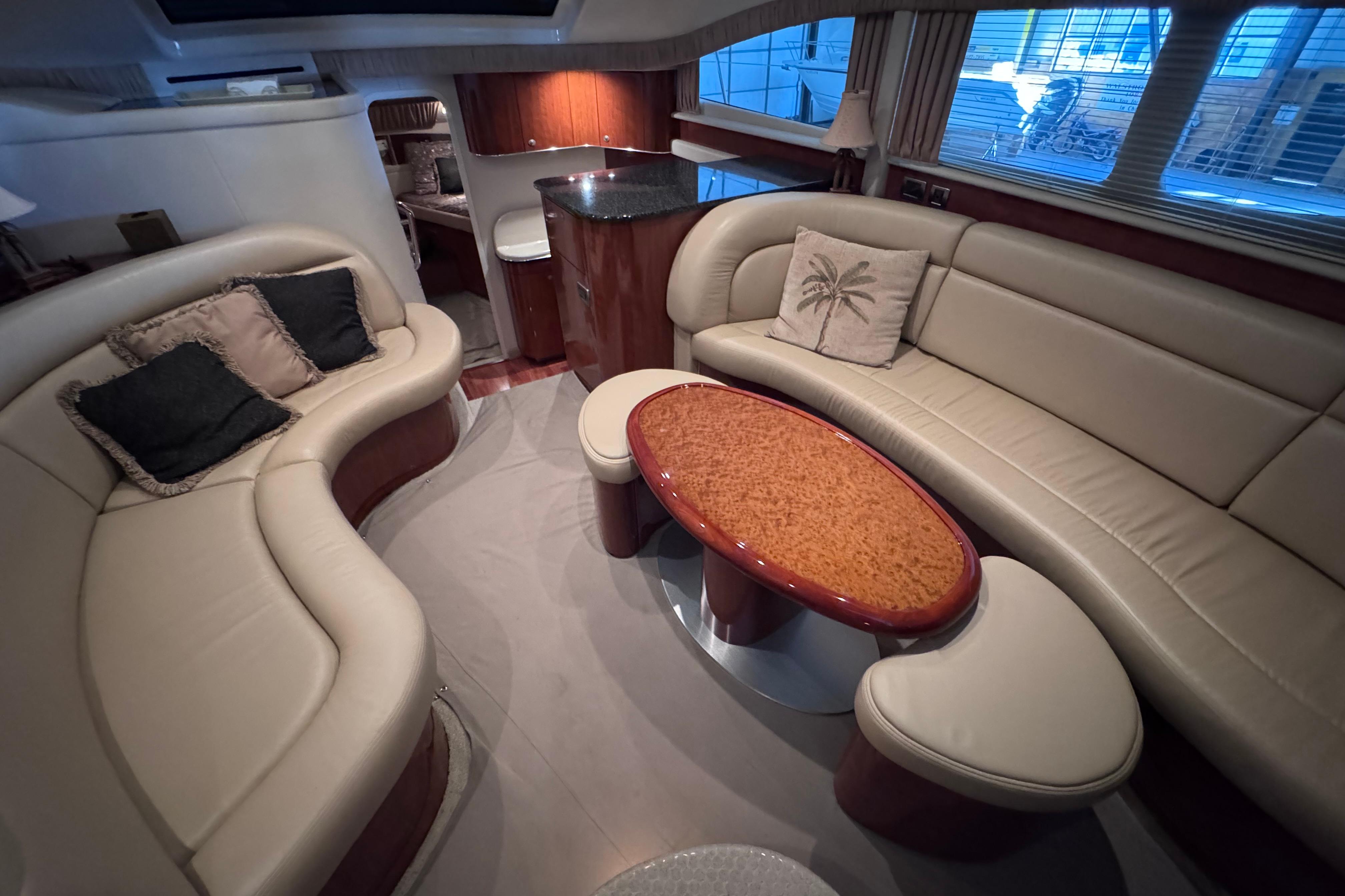 Luxurious interior of 2004 Sea Ray 390 Motor Yacht with elegant seating and table.