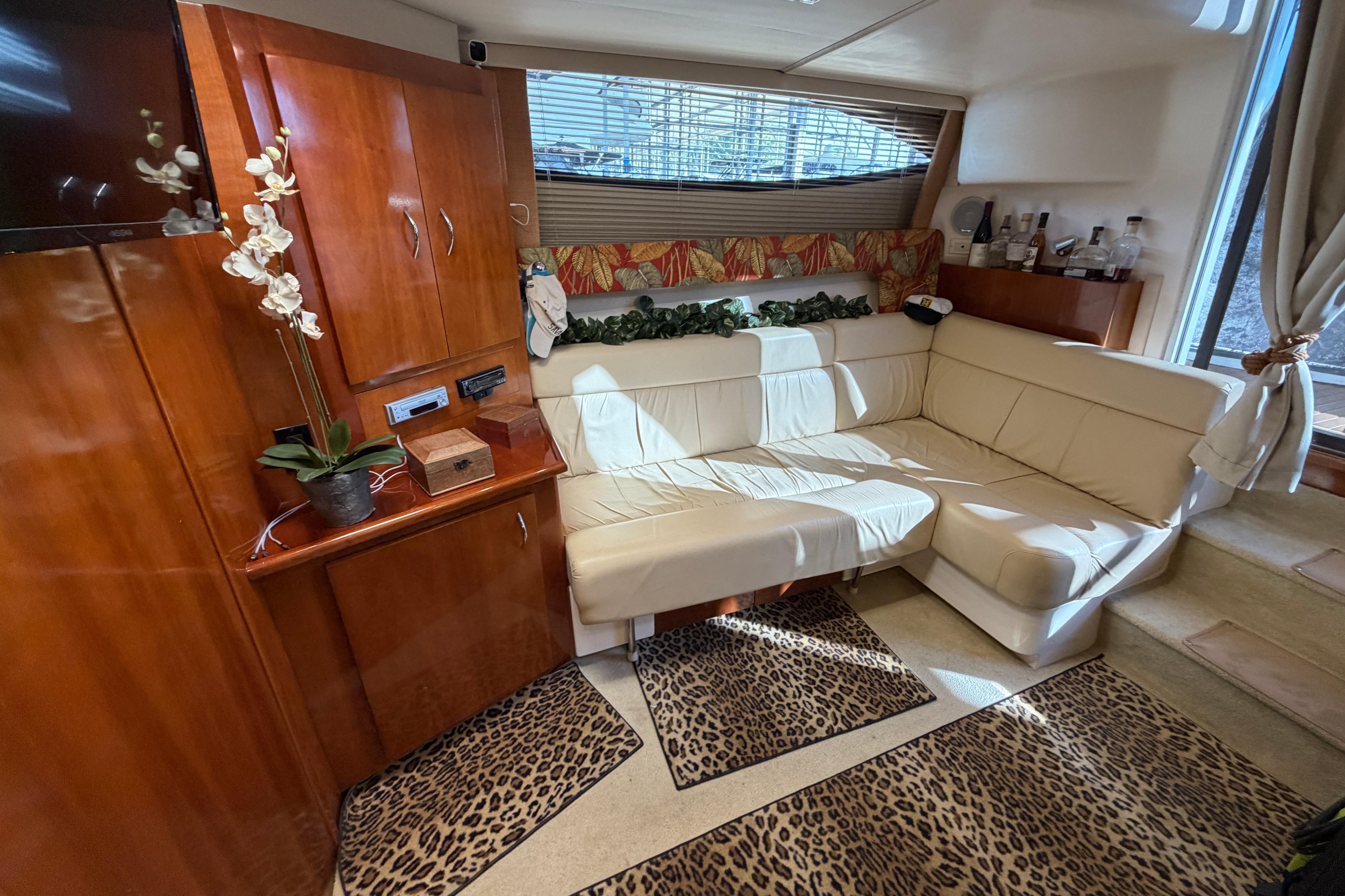 Luxurious interior of a 2003 Carver 350 Mariner yacht with elegant wood finishes.