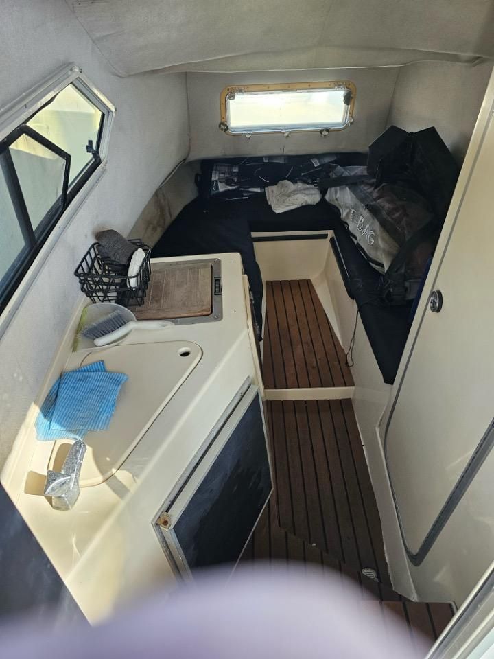 Interior of a 1991 Pro-Line Cuddy Cabin with wooden flooring.