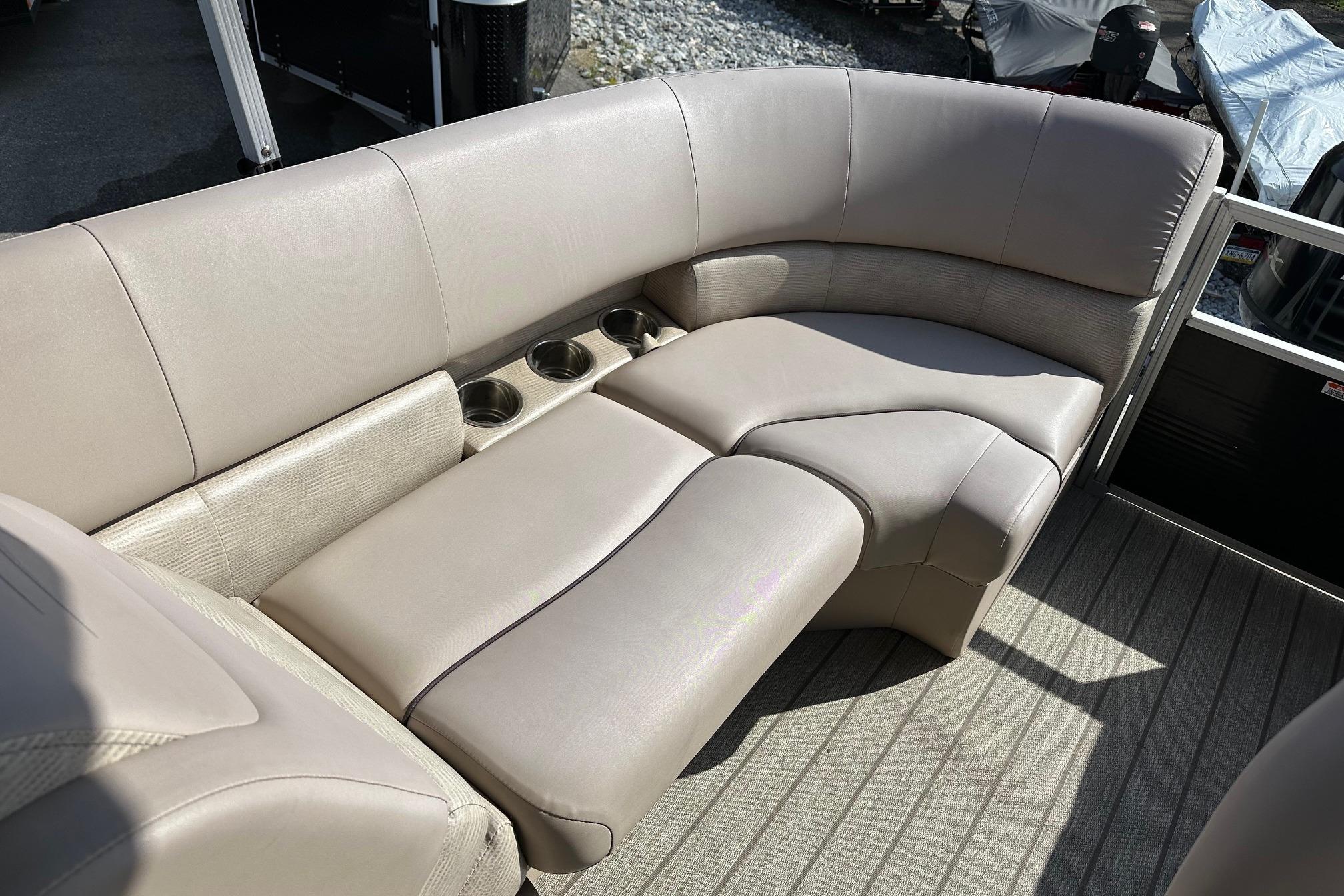 Luxurious seating on 2017 Bennington 22 GPD pontoon boat with cup holders.
