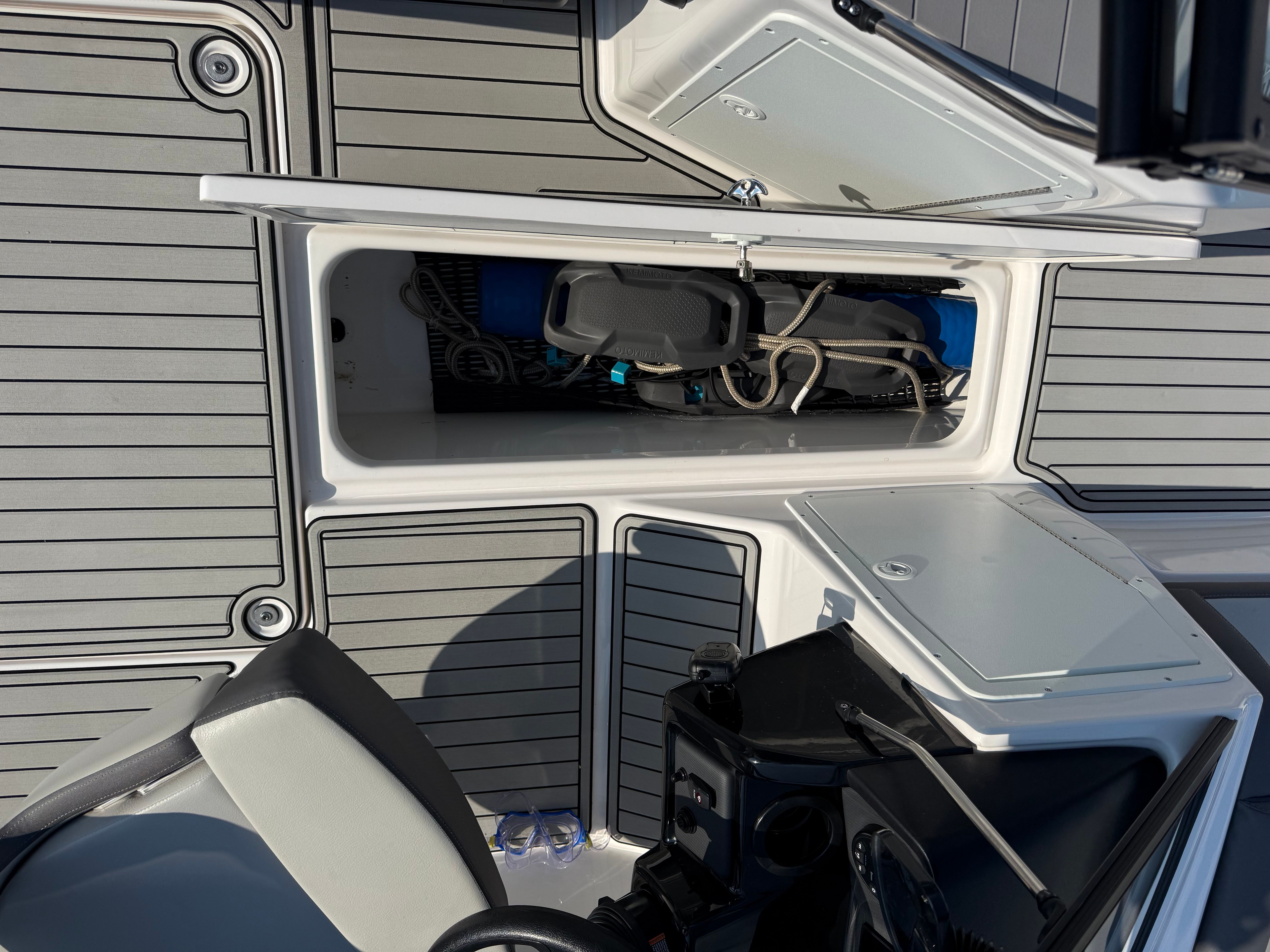 The image shows the deck of a Yamaha AR190 boat with storage compartments and a helm.