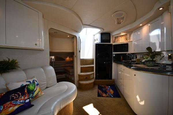 Interior of 1997 Sea Ray 400 Sundancer yacht with modern kitchen and seating area.