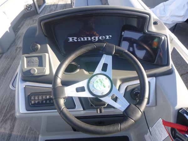 2024 Ranger Reata 223C boat dashboard with steering wheel and controls.