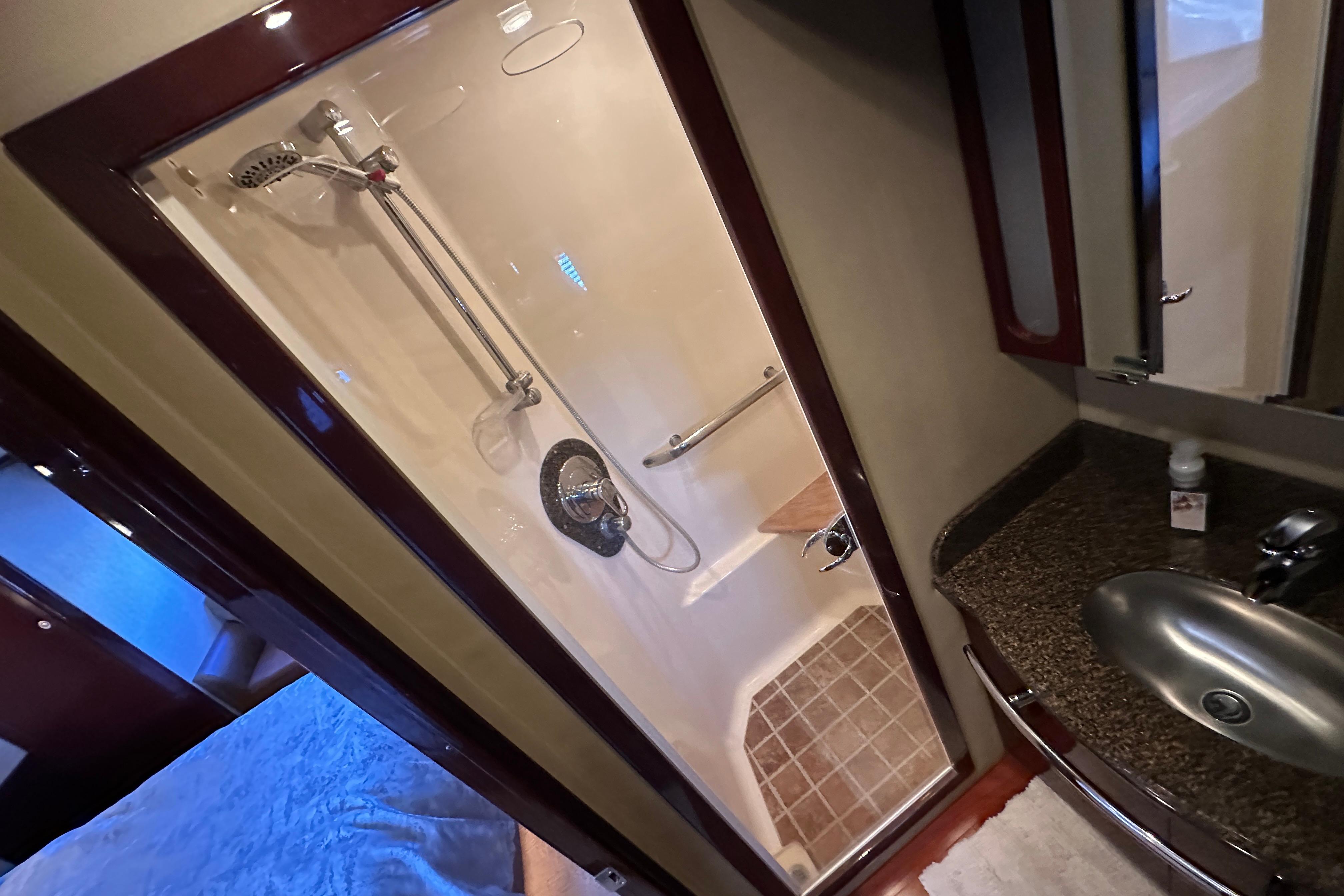 Luxurious bathroom in 2007 Sea Ray 60 Sundancer yacht with shower and sink.