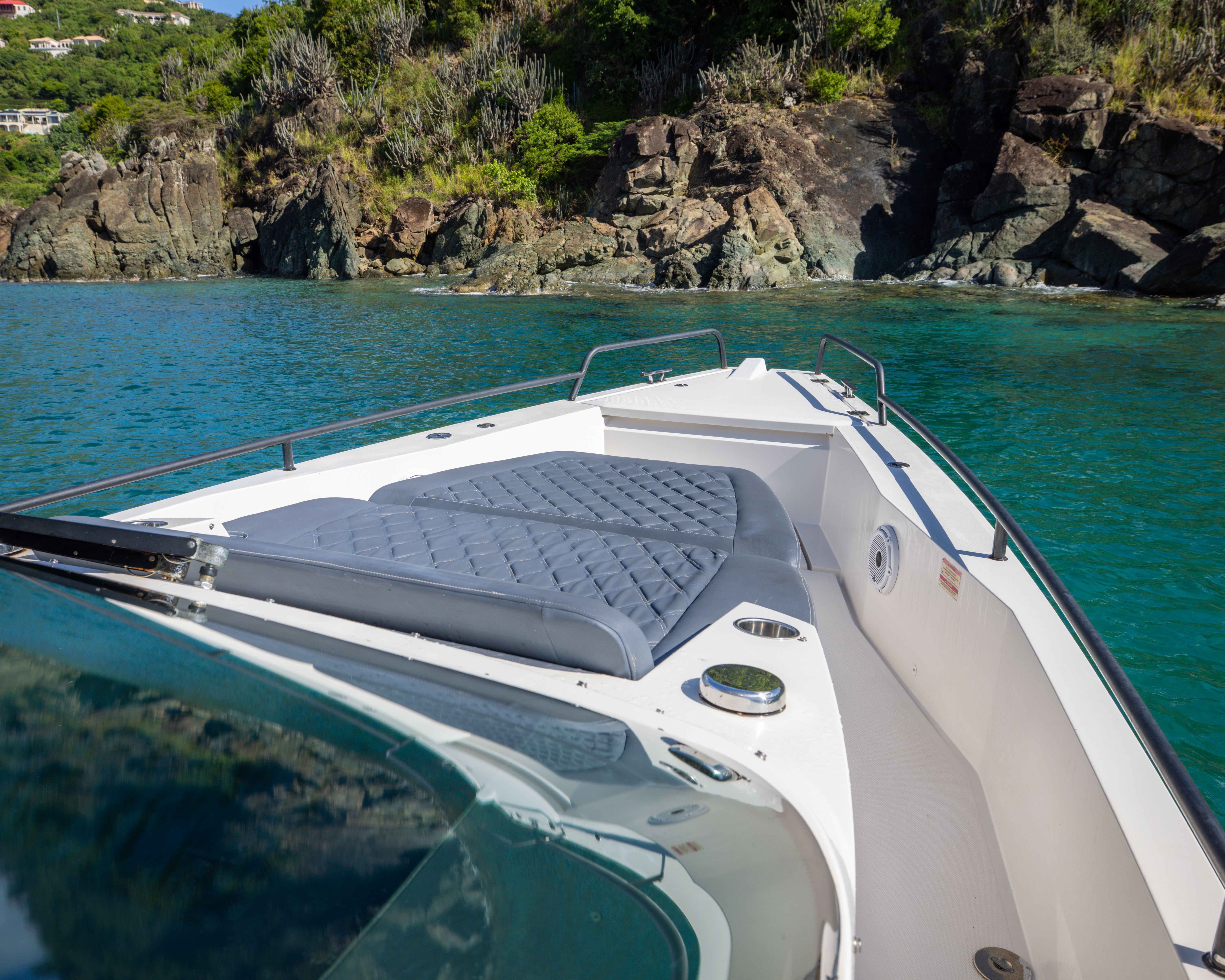 2020 Axopar 37 SUN TOP in a scenic cove with turquoise water.