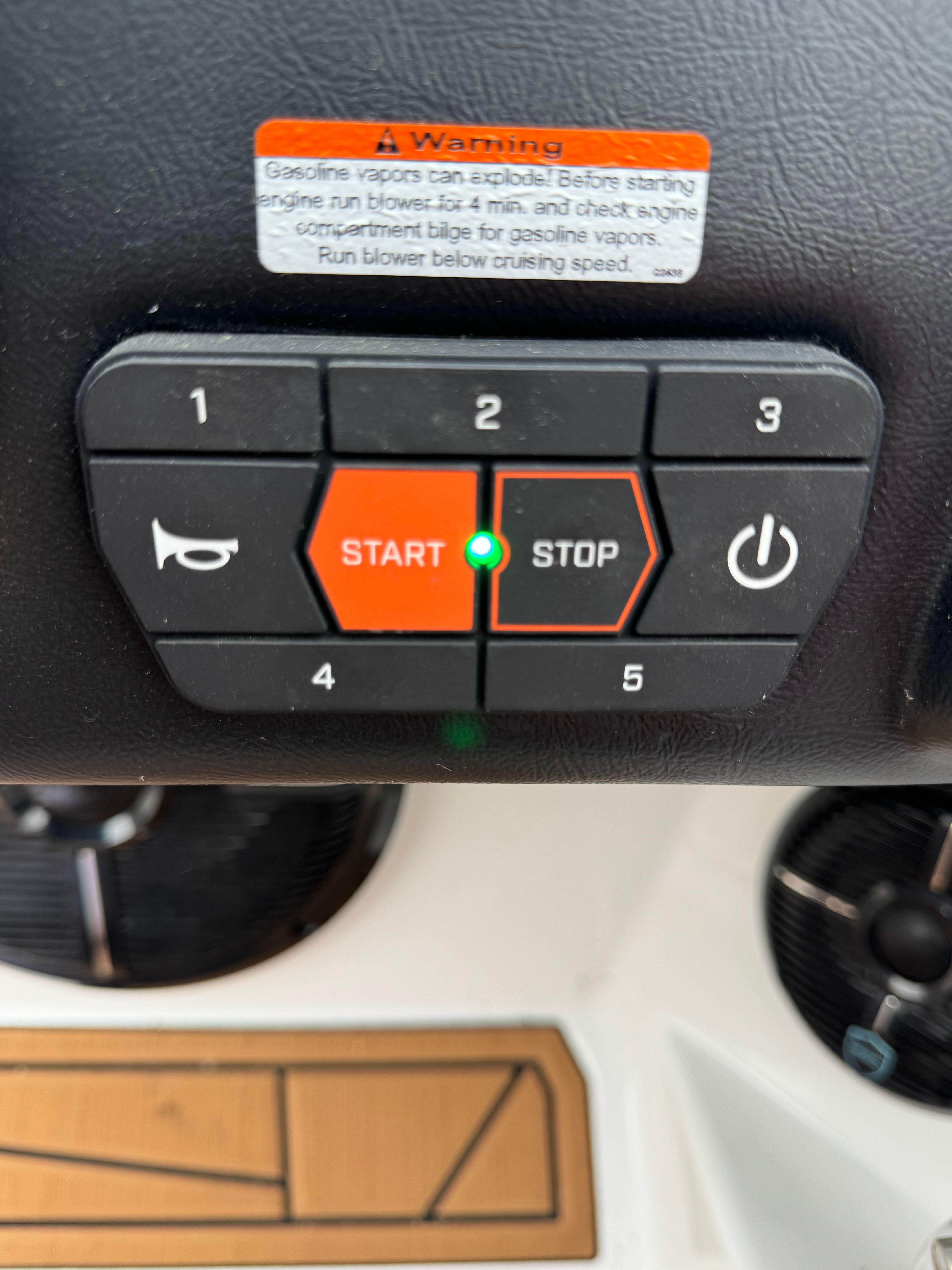 Control panel of an ATX Surf Boats 22 Type-S with start and stop buttons.