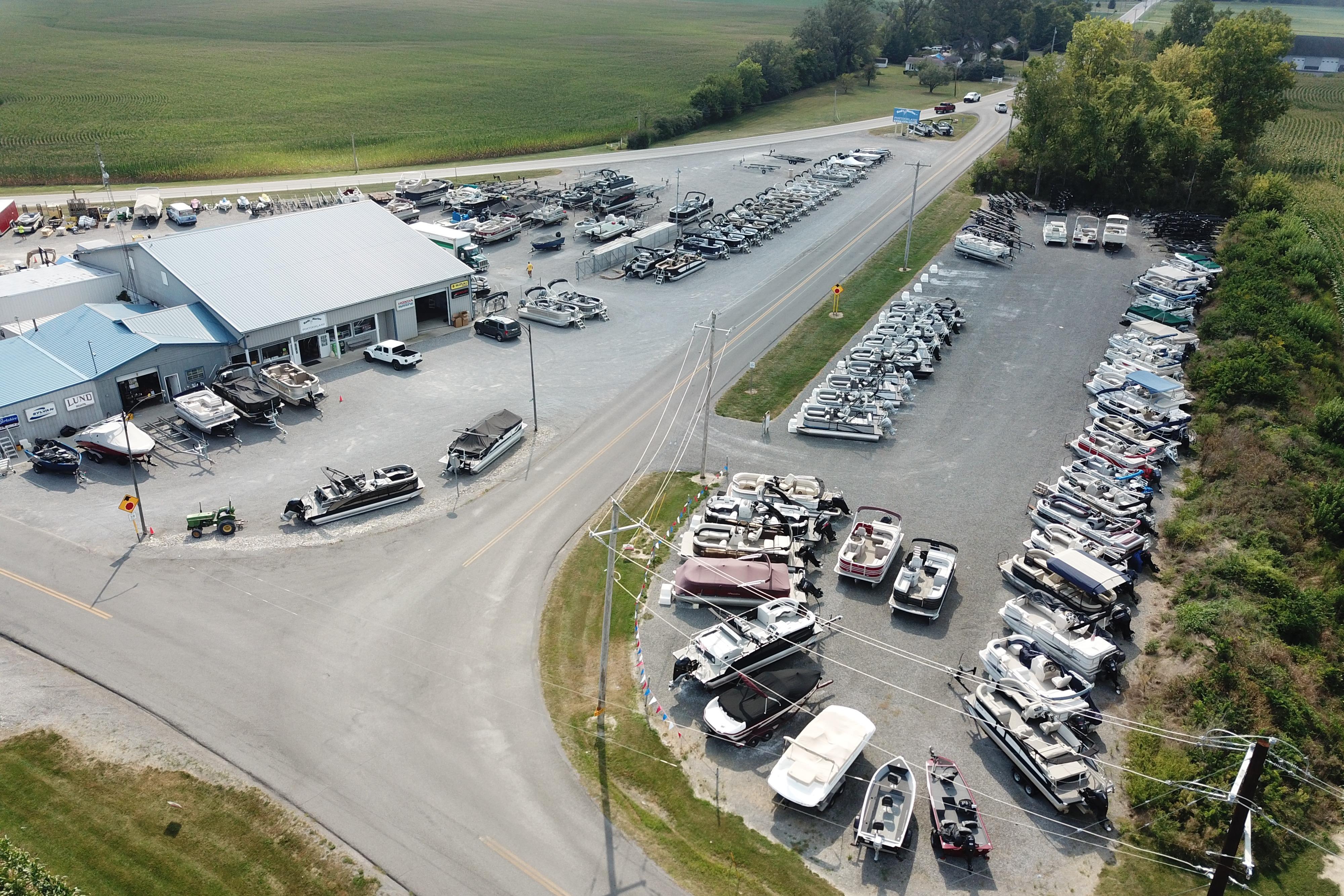 Aerial view of a boat dealership showcasing various boats, including the 2026 Barletta ARIA 20CC.