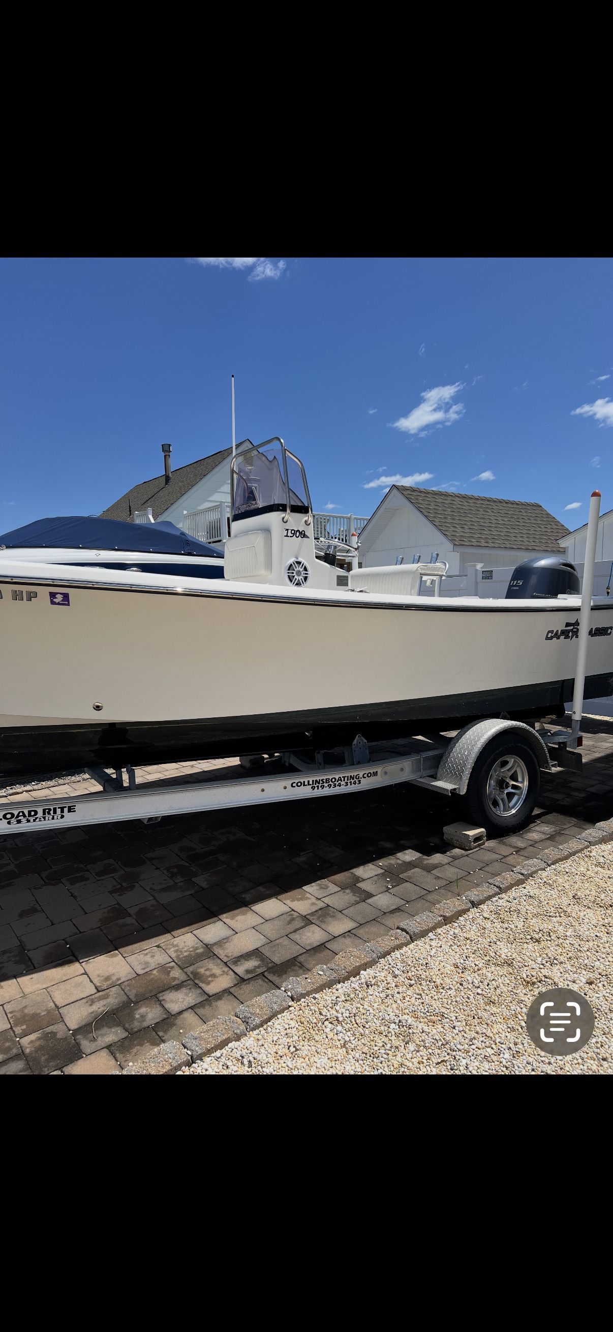 A 2020 Center Console Maycraft boat on a trailer, parked on a paved area.