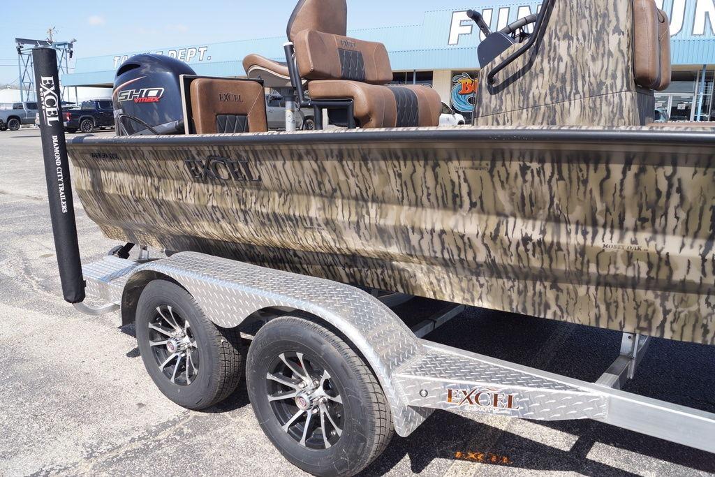 2026 Excel 203 Bay Pro Elite boat on trailer, camo design, parked outdoors.