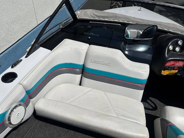 1992 Correct Craft Ski Nautique interior with white and teal seating, dashboard, and steering wheel.