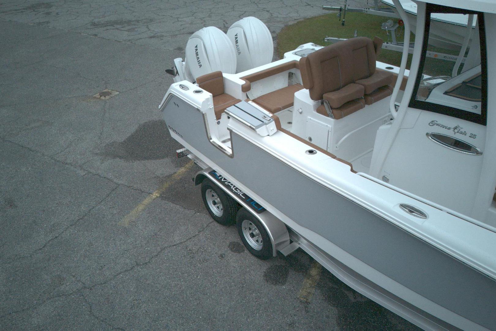 2026 Sea Hunt Gamefish 25 boat on trailer, featuring dual Yamaha engines.