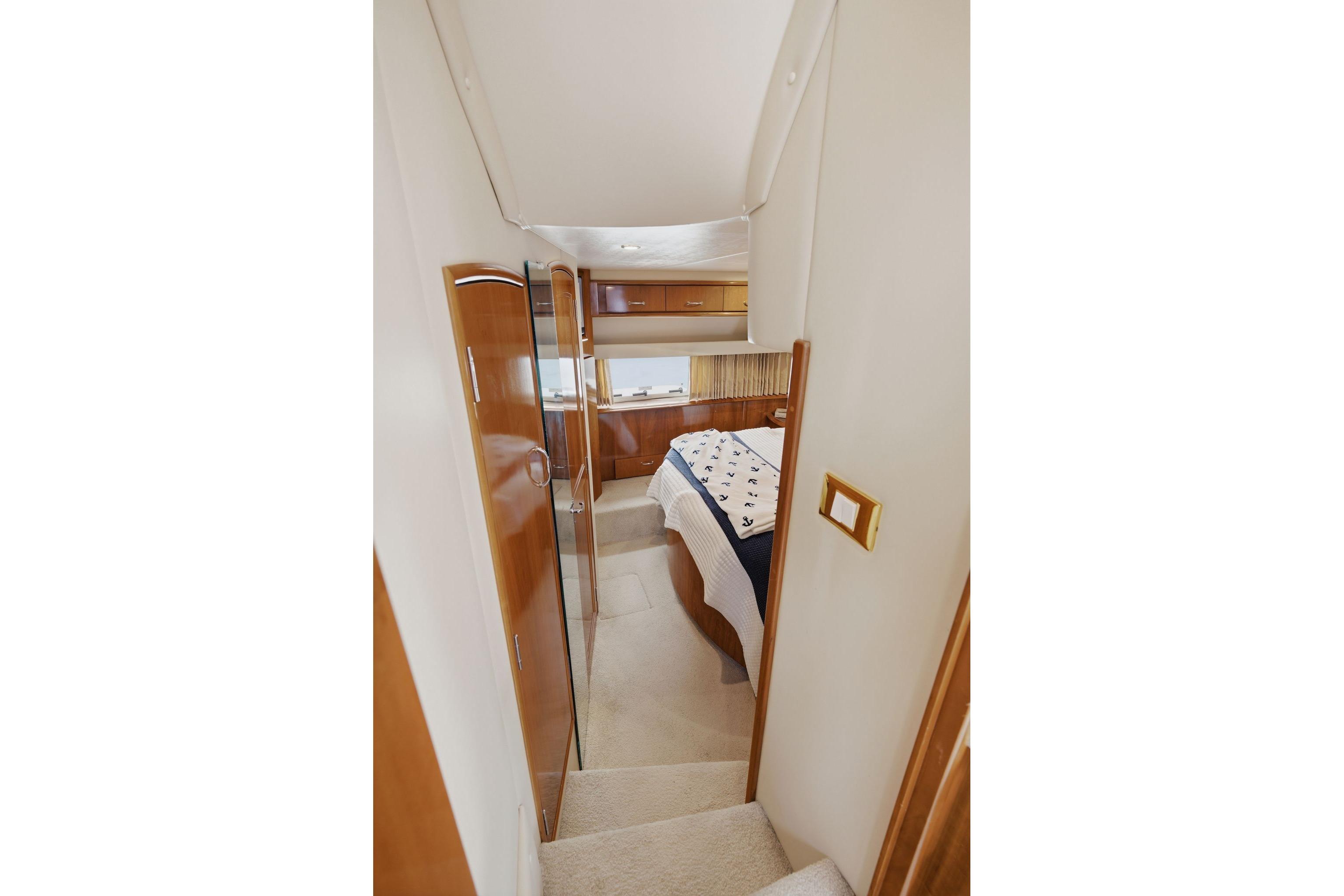 Interior of 2005 Carver 39 Motor Yacht showing bedroom with nautical-themed bedding.