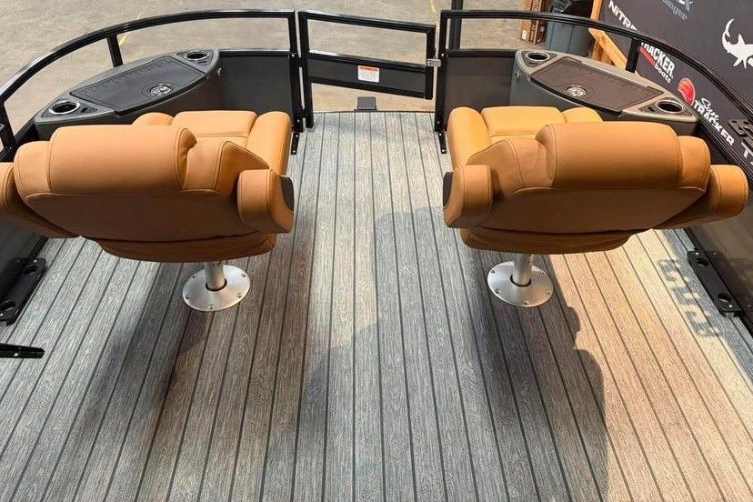 Two tan captain chairs on a 2026 Ranger 220F boat deck.