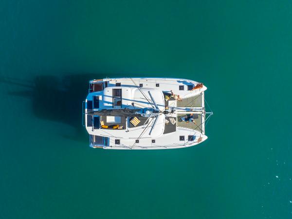 Aerial view of 2025 Lagoon 43 catamaran on turquoise water.