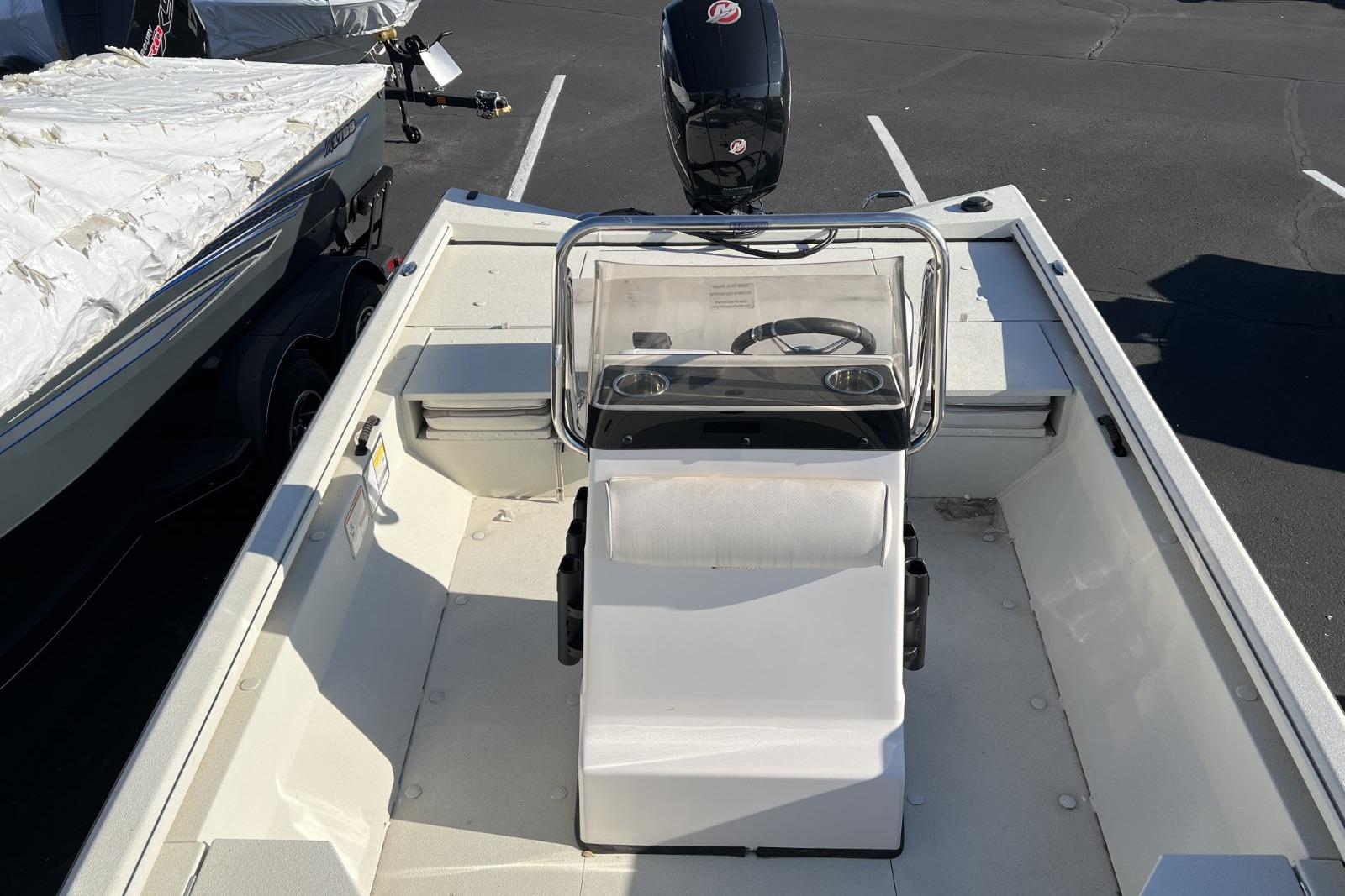 2024 Ranger RB200 boat interior with steering console and seating, parked outdoors.