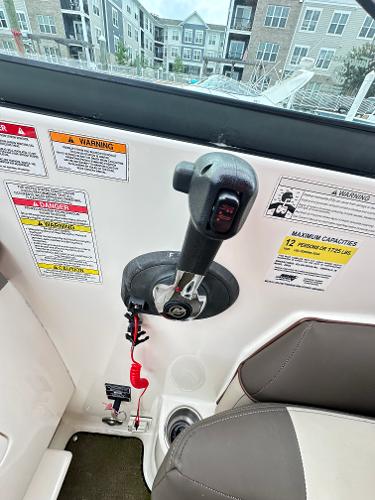2015 Sea Ray 260 Sundancer control panel with throttle and safety warnings.