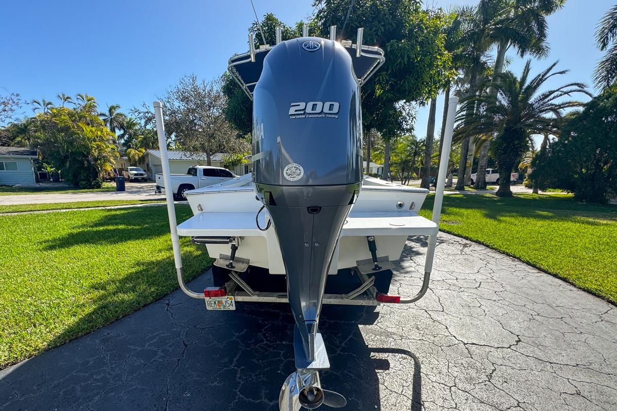 1972 Cuda Craft Open Fisherman boat with Yamaha 200 outboard motor on driveway.