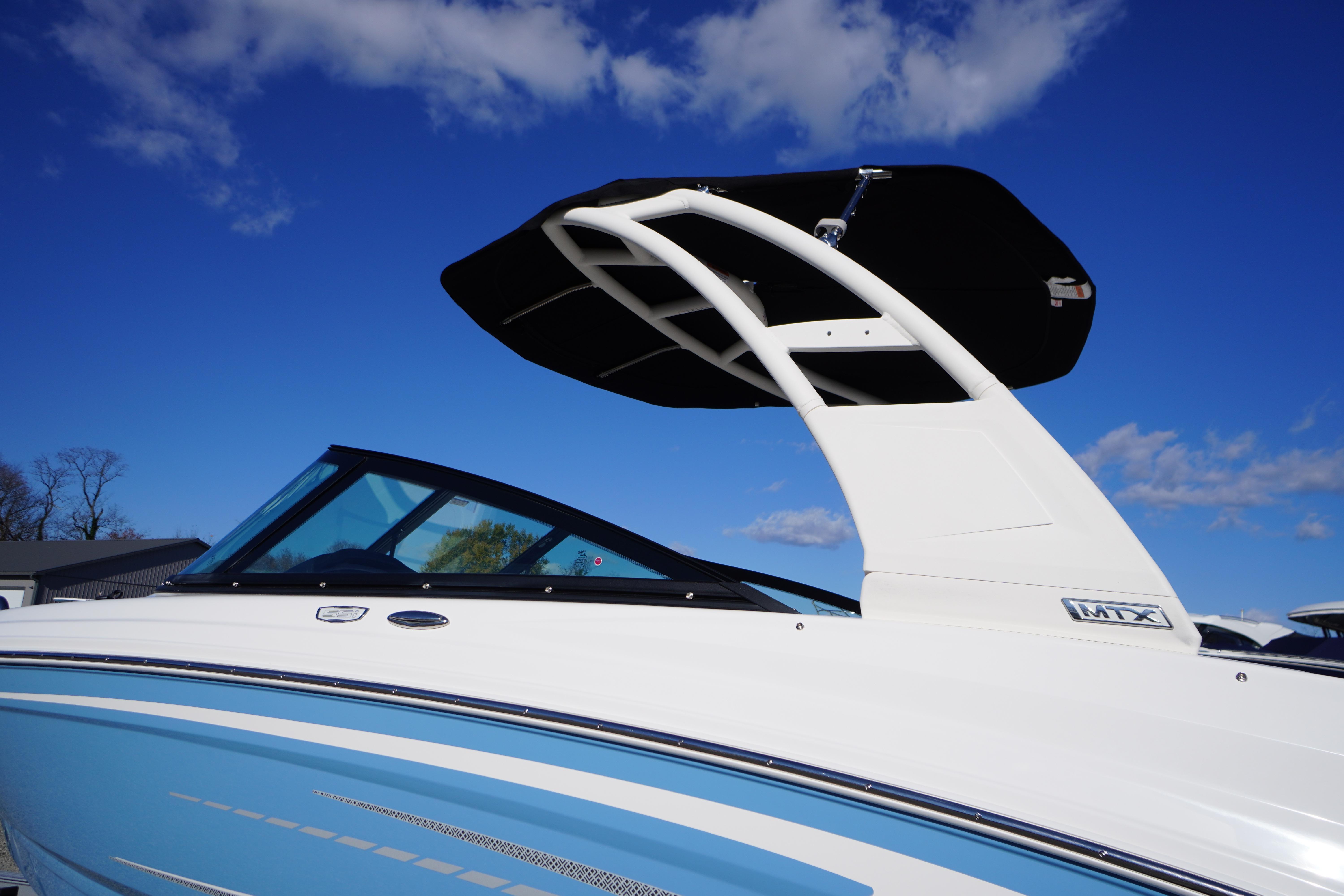 2026 Chaparral 23 SSi boat with sleek design against a clear blue sky.