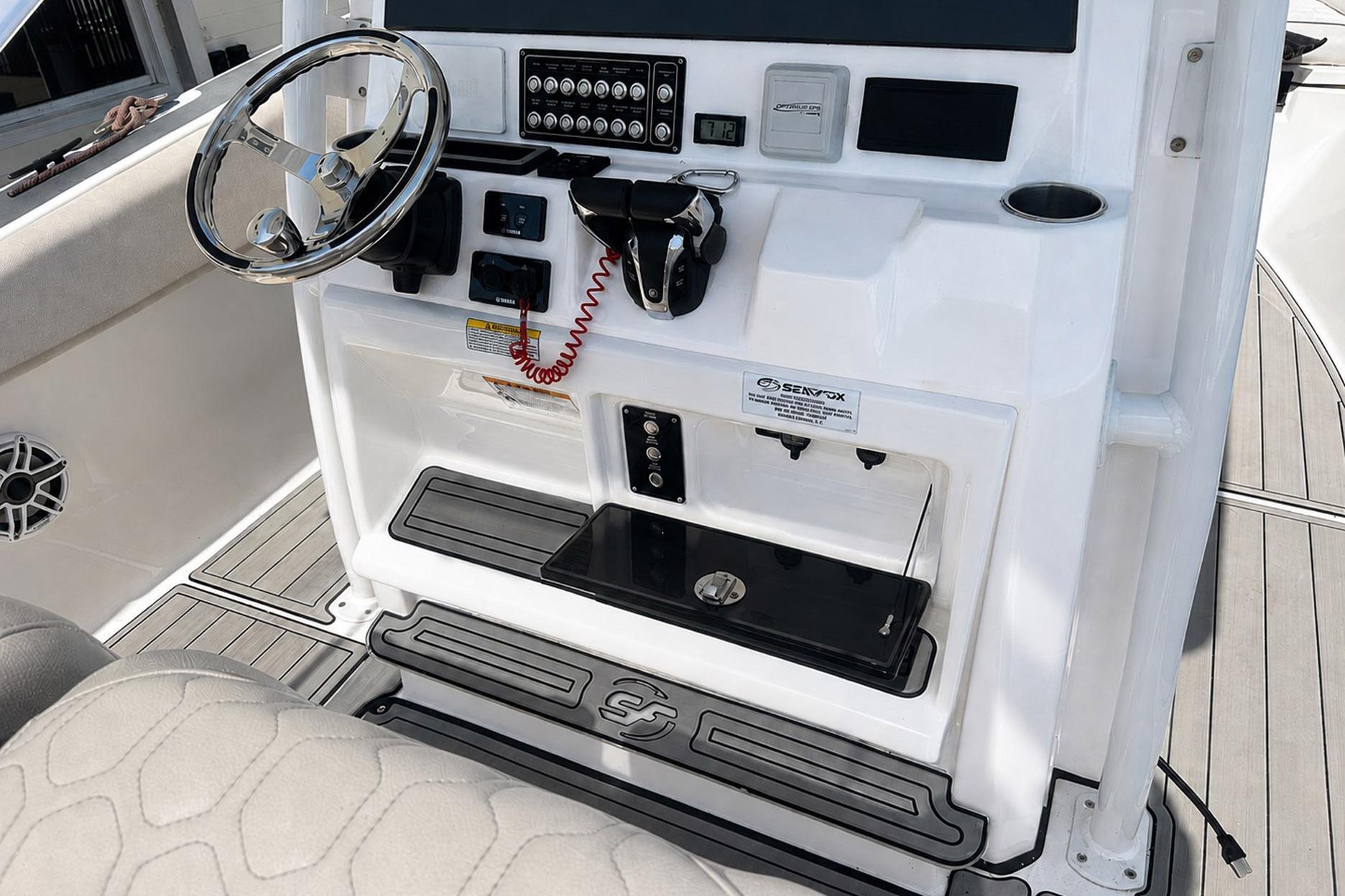Console of a 2002 Sea Fox 228 Commander boat with steering wheel and controls.