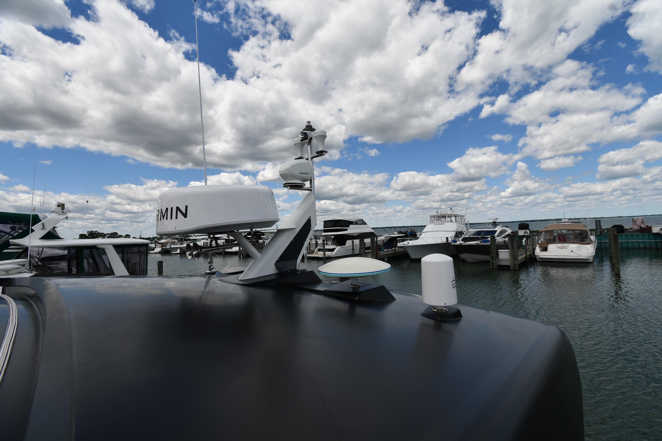 2024 Fairline G50 Targa yacht docked at marina under cloudy sky.