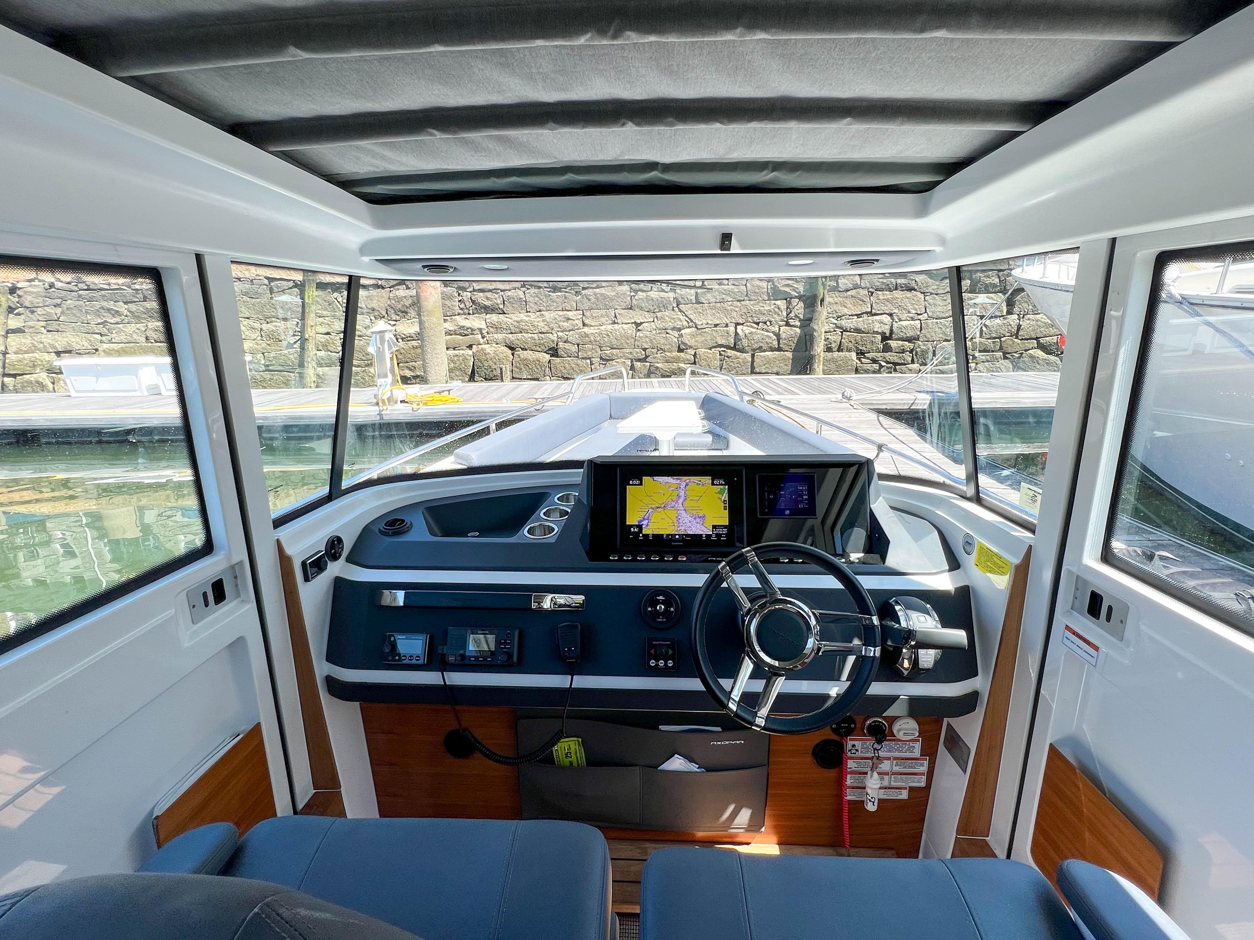 Interior view of 2020 Axopar 28 Cabin with modern helm console.
