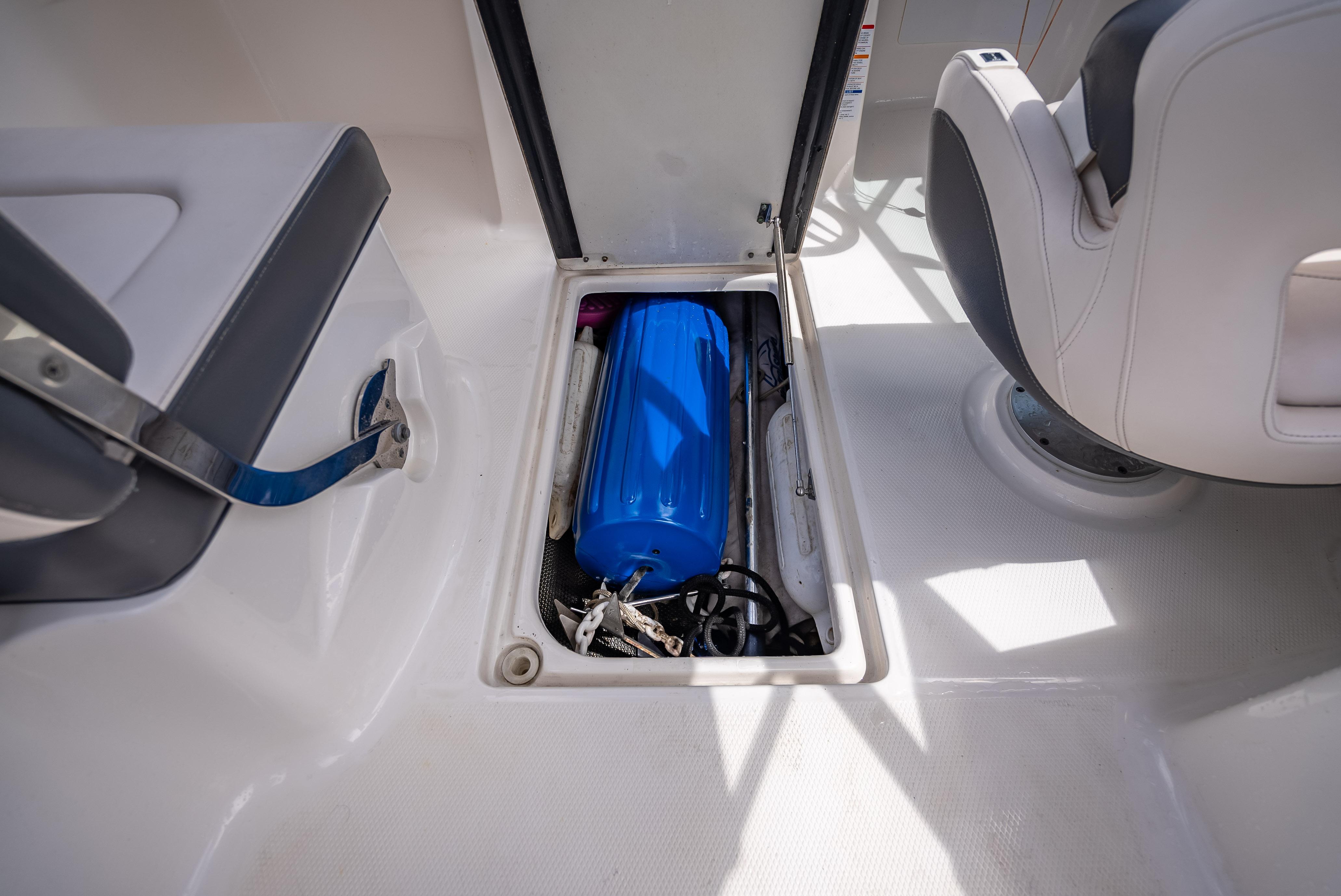 Storage compartment in 2017 Chaparral 227 SSX boat with blue equipment inside.