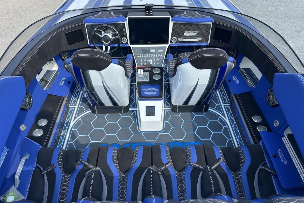 Luxurious 2018 Wright Performance 420 boat interior with blue accents and advanced dashboard controls.