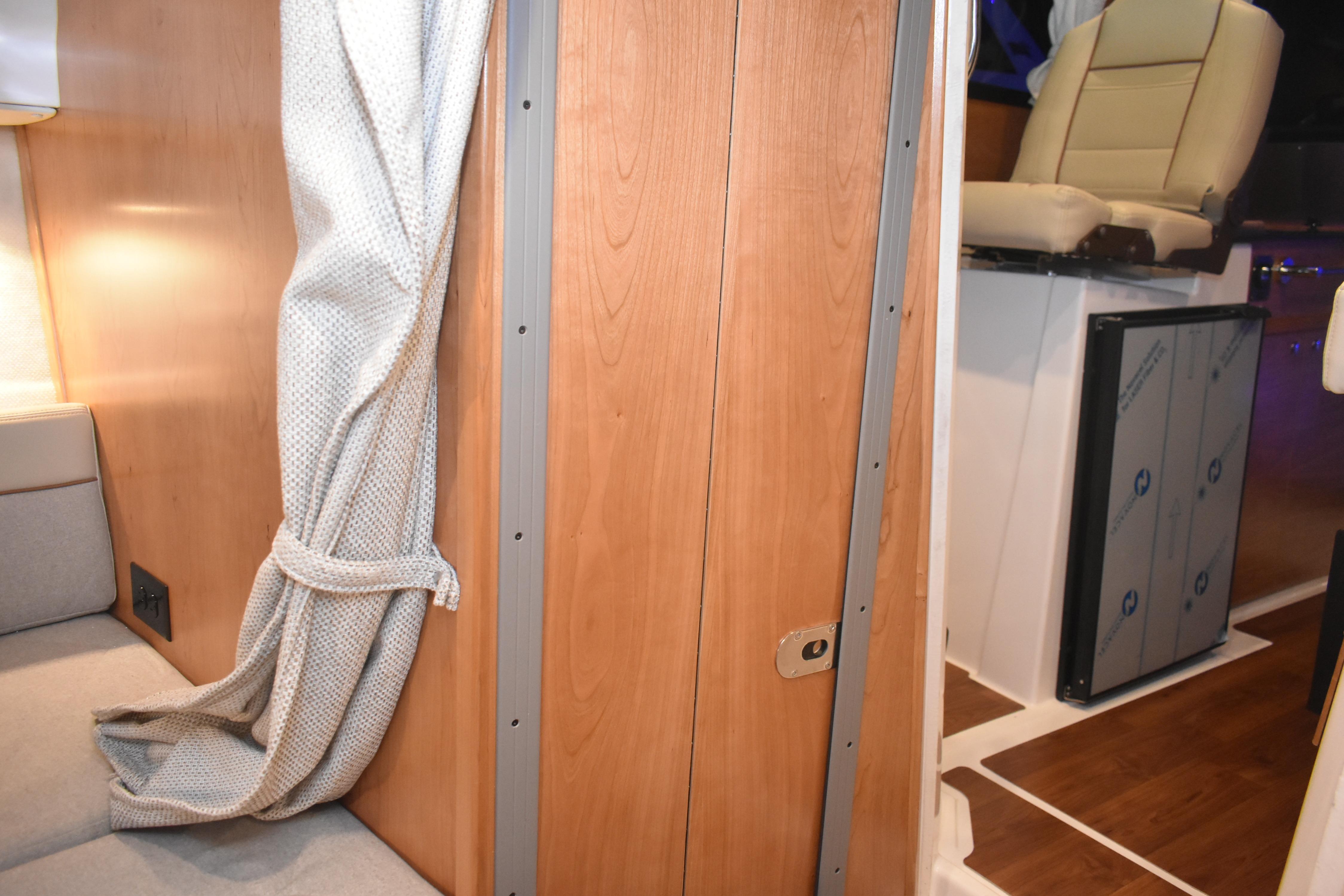2026 Cutwater C-248 Coupe interior with wooden paneling and seating area.