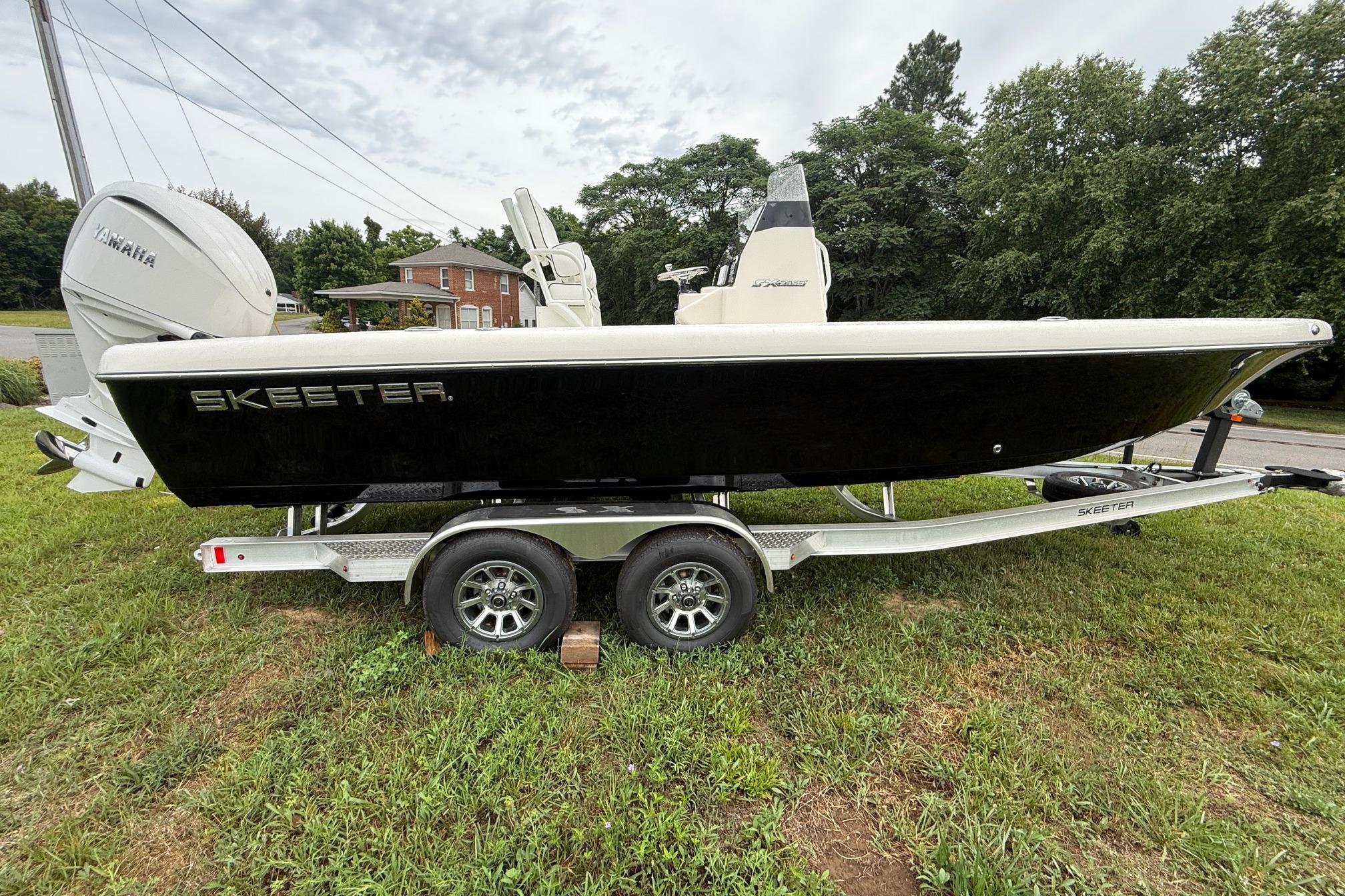 2026 Skeeter SX2350 boat on trailer with Yamaha engine, parked on grass.