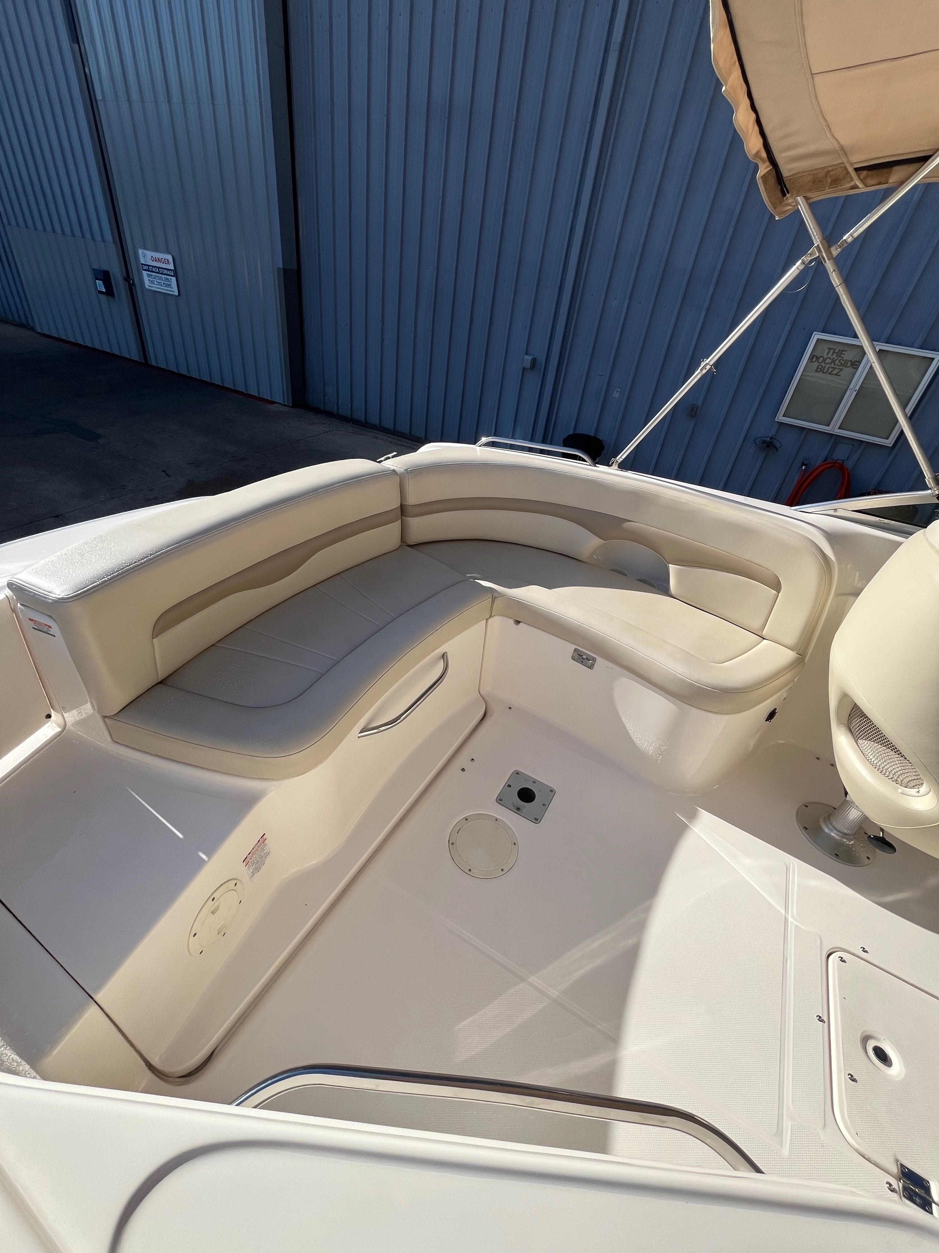 Interior view of a 2003 Chaparral 230 SSi boat with beige seating.