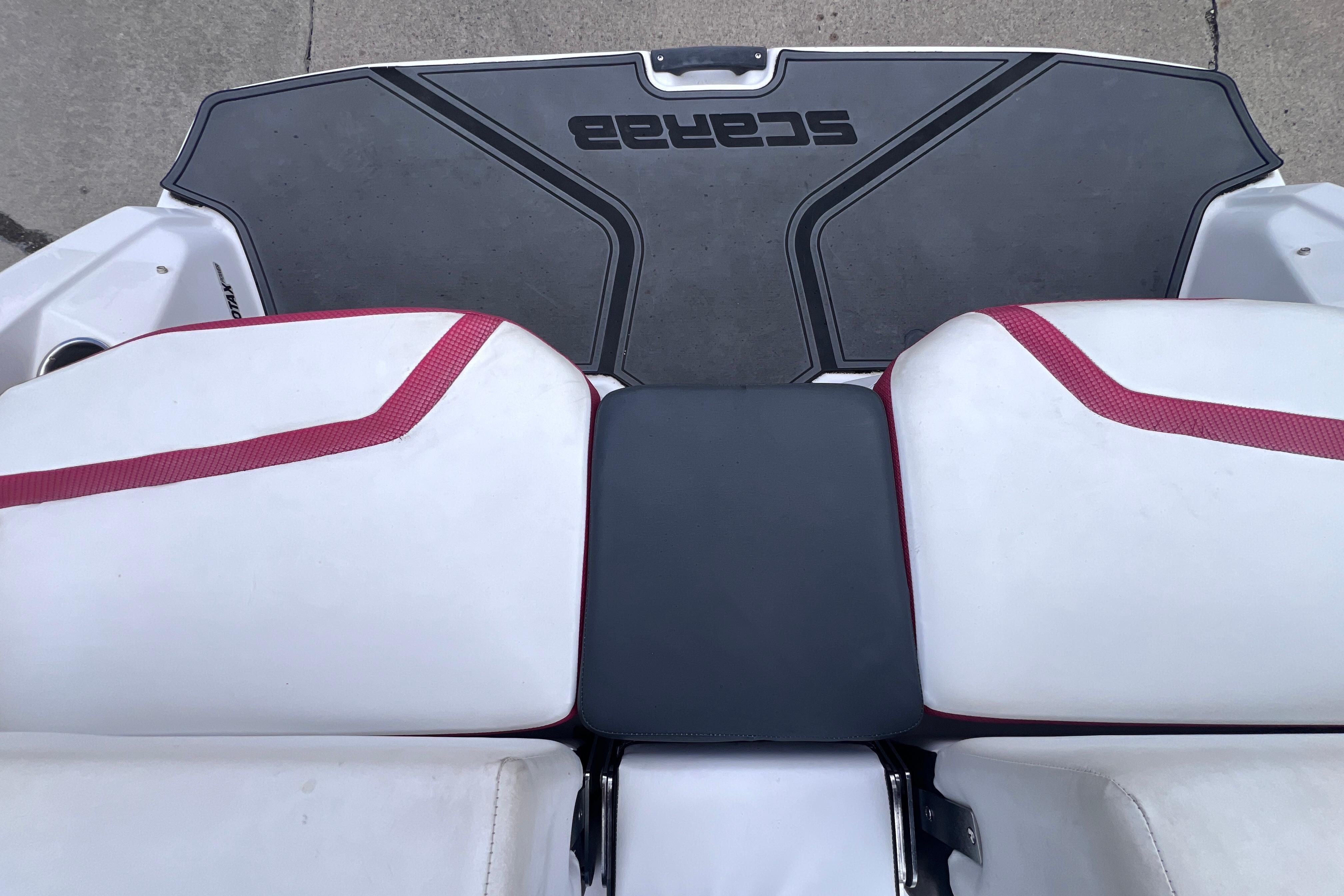 Rear seating and deck of 2014 Scarab 195 H.O. boat with red accents.