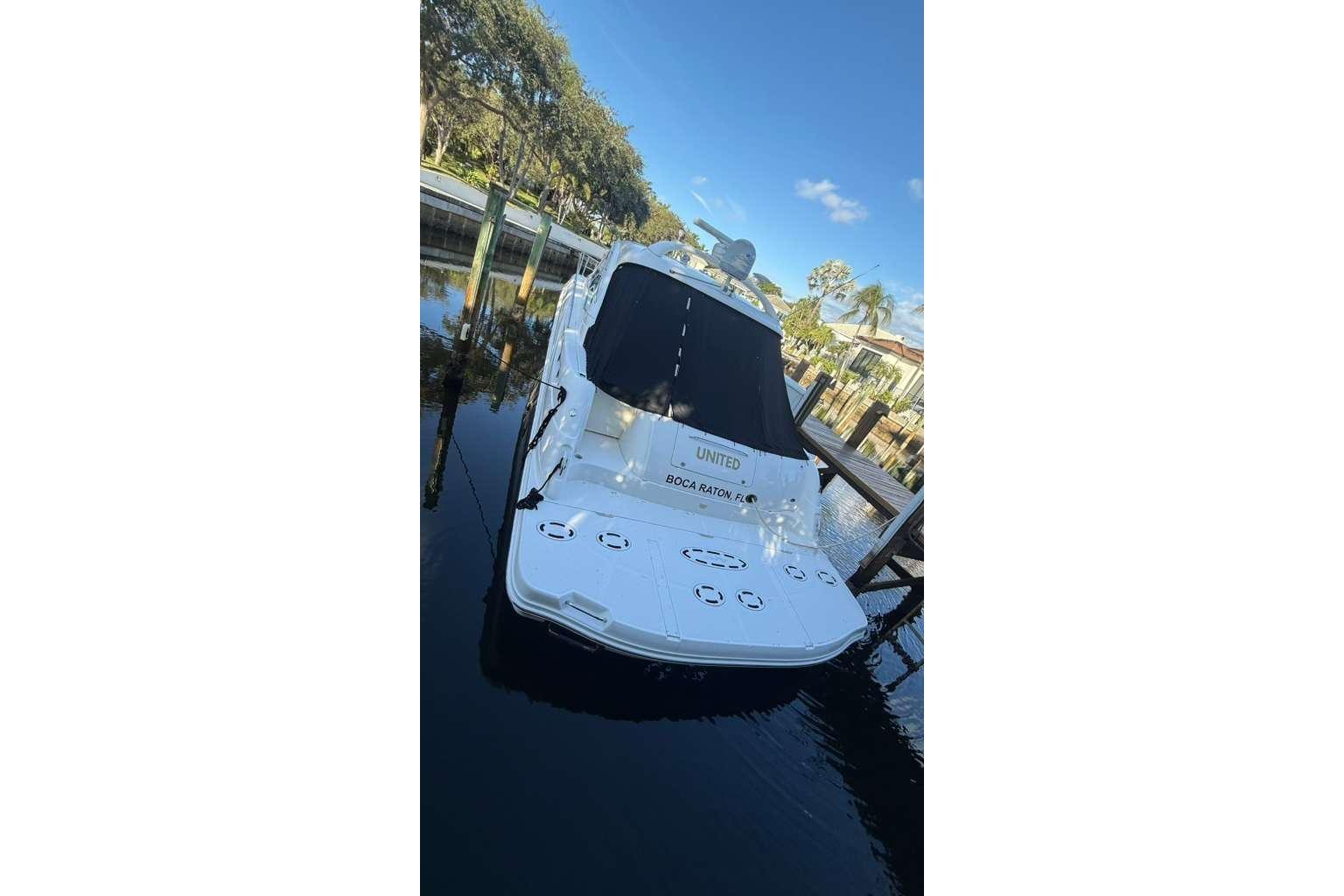 2007 Sea Ray 48 Sundancer yacht docked in a serene marina setting.