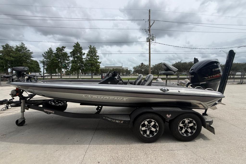 2018 Phoenix 919 ProXP boat on trailer, parked outdoors under cloudy sky.
