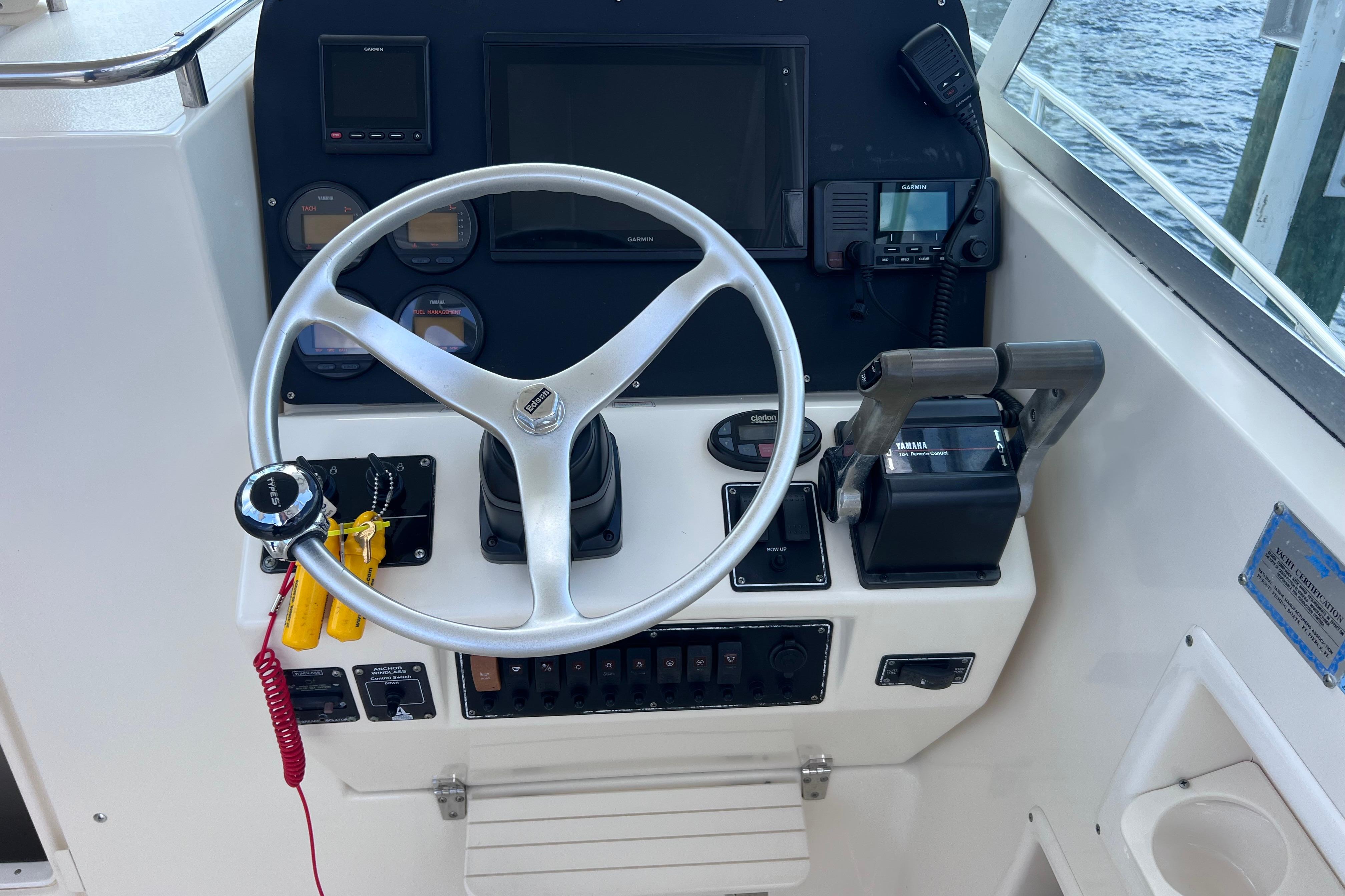 2004 Pursuit 2870 Walkaround boat helm with steering wheel and control panel.