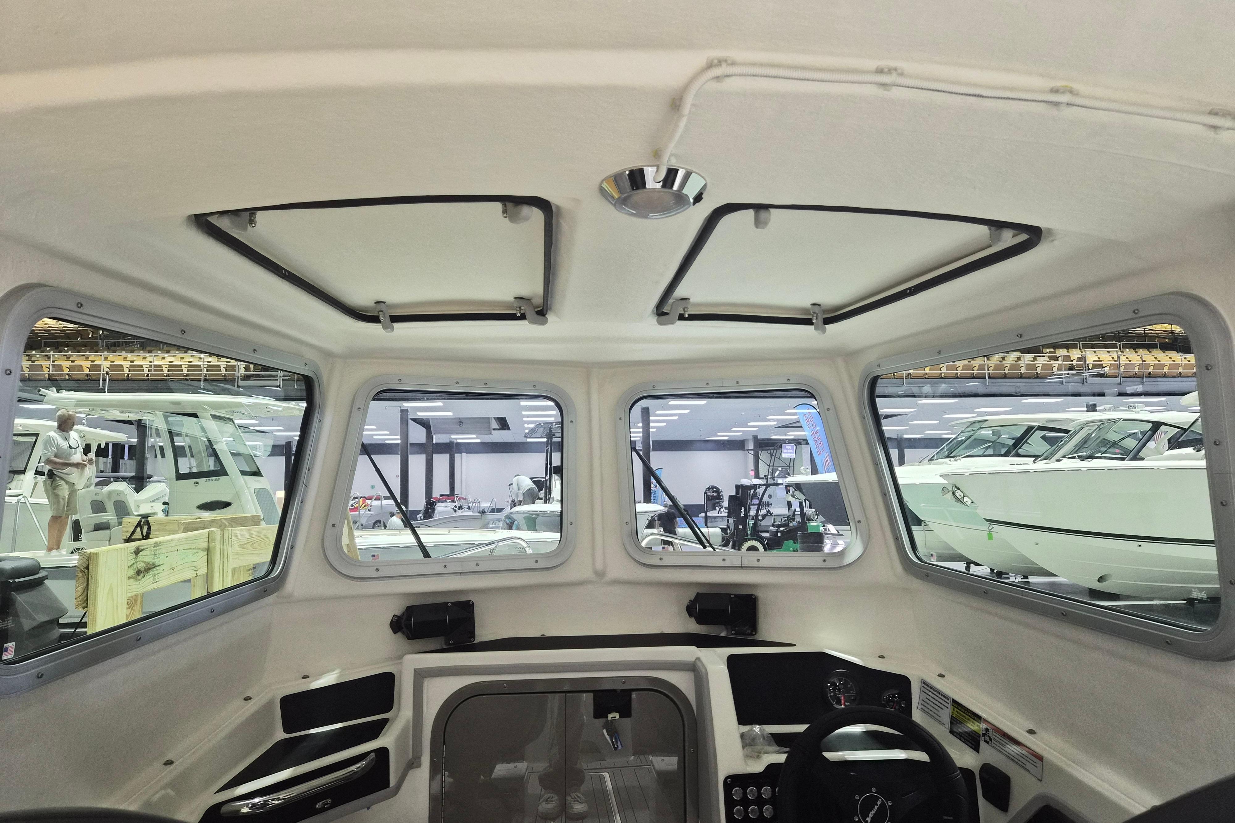 Interior view of 2026 Arima Sea Chaser 19 Yellowtail Edition boat at a showroom.