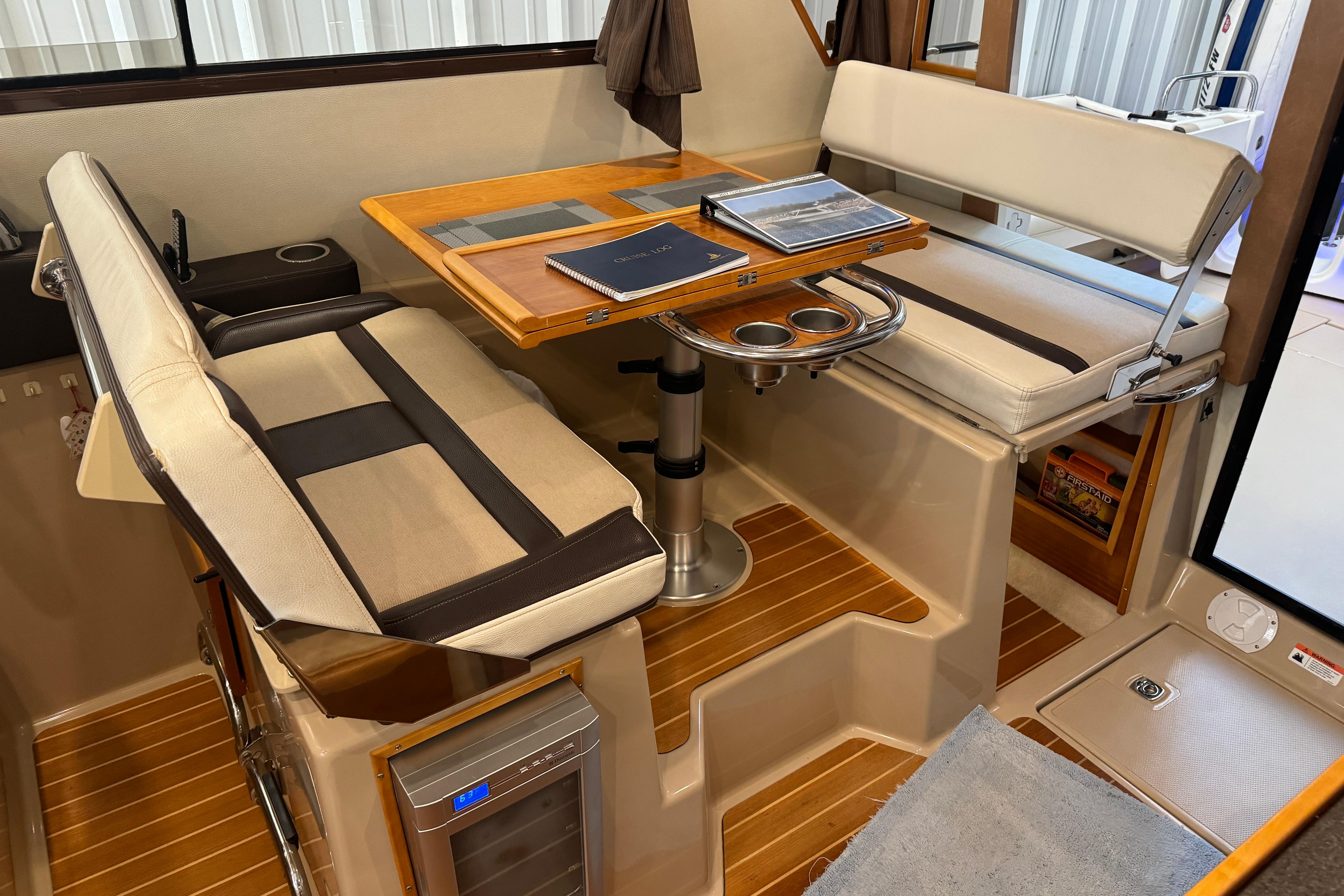 Interior of 2017 Cutwater C-30 Sedan with dining area and wooden flooring.