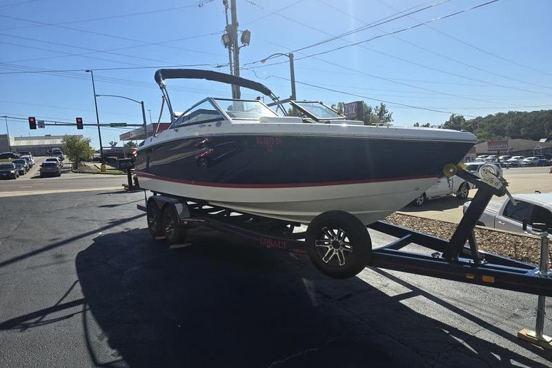 2022 Cobalt R4 boat on trailer in parking lot, sunny day.