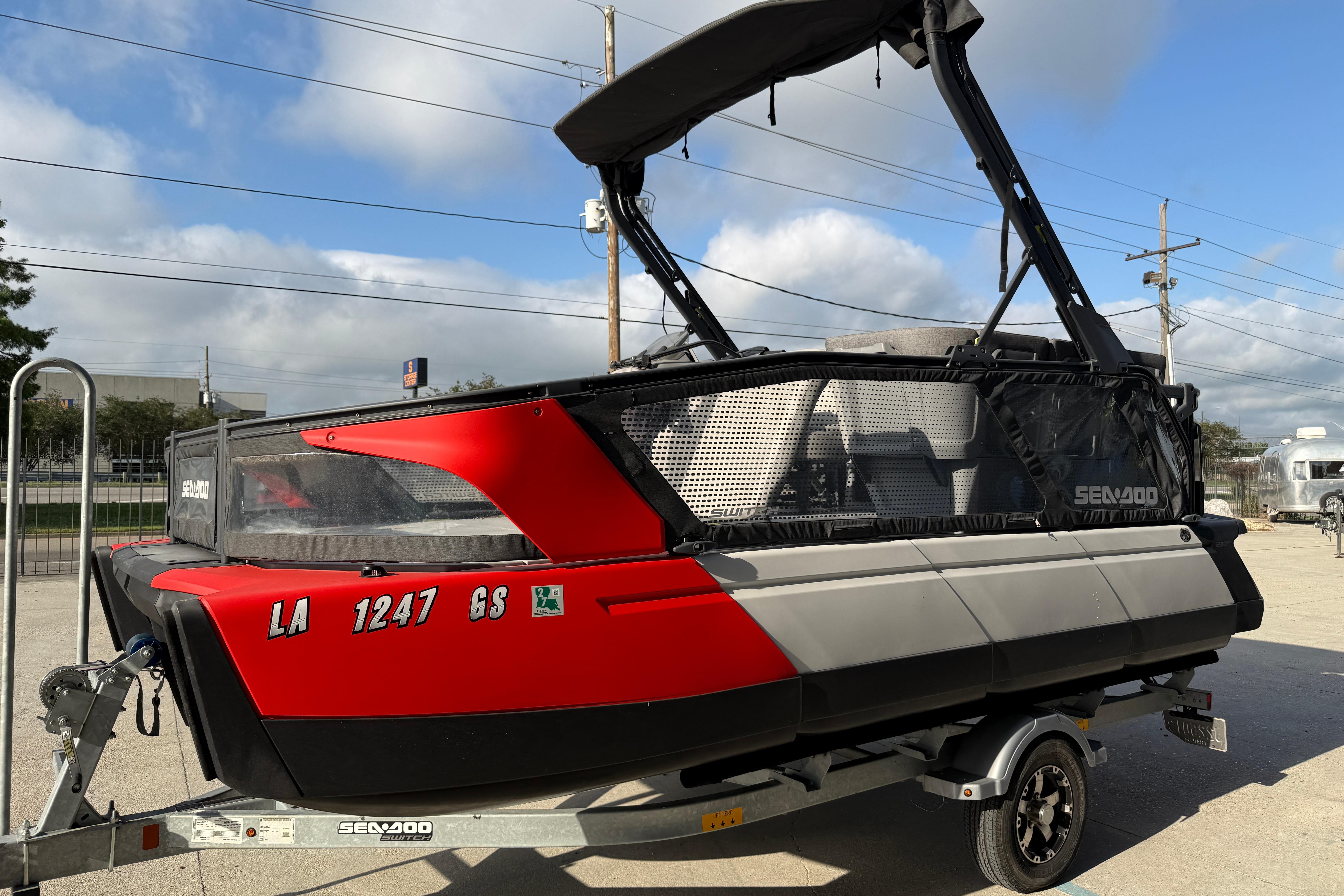 2023 Sea-Doo Switch Sport 18 on trailer, featuring sleek red and black design.