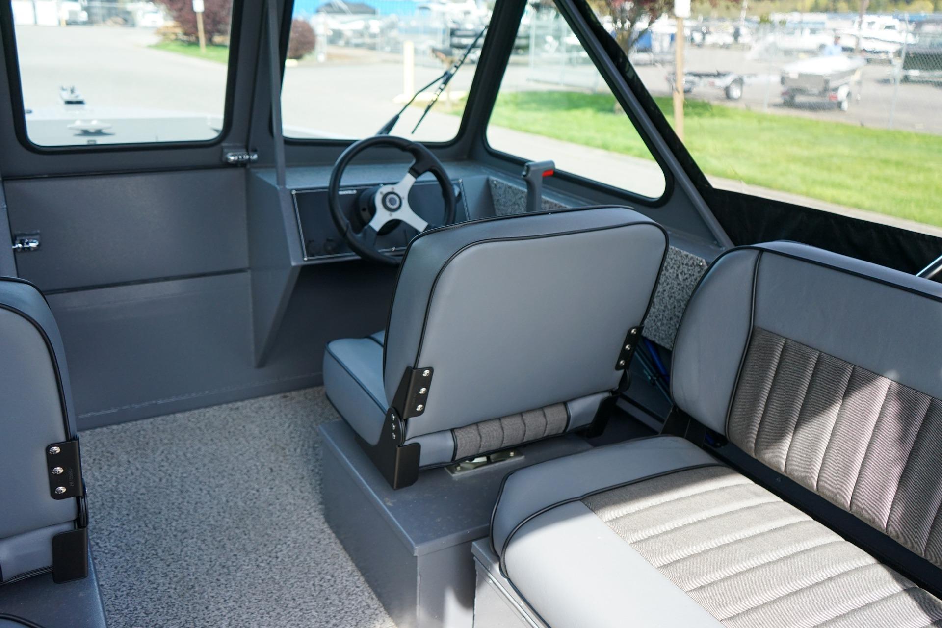 Interior of 2026 Alumaweld Talon 18 boat, featuring modern seating and steering wheel.
