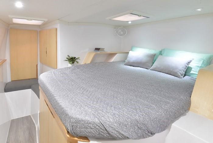 Modern bedroom interior of Seawind 1170 yacht, 2025 model, with cozy bed and minimalist design.