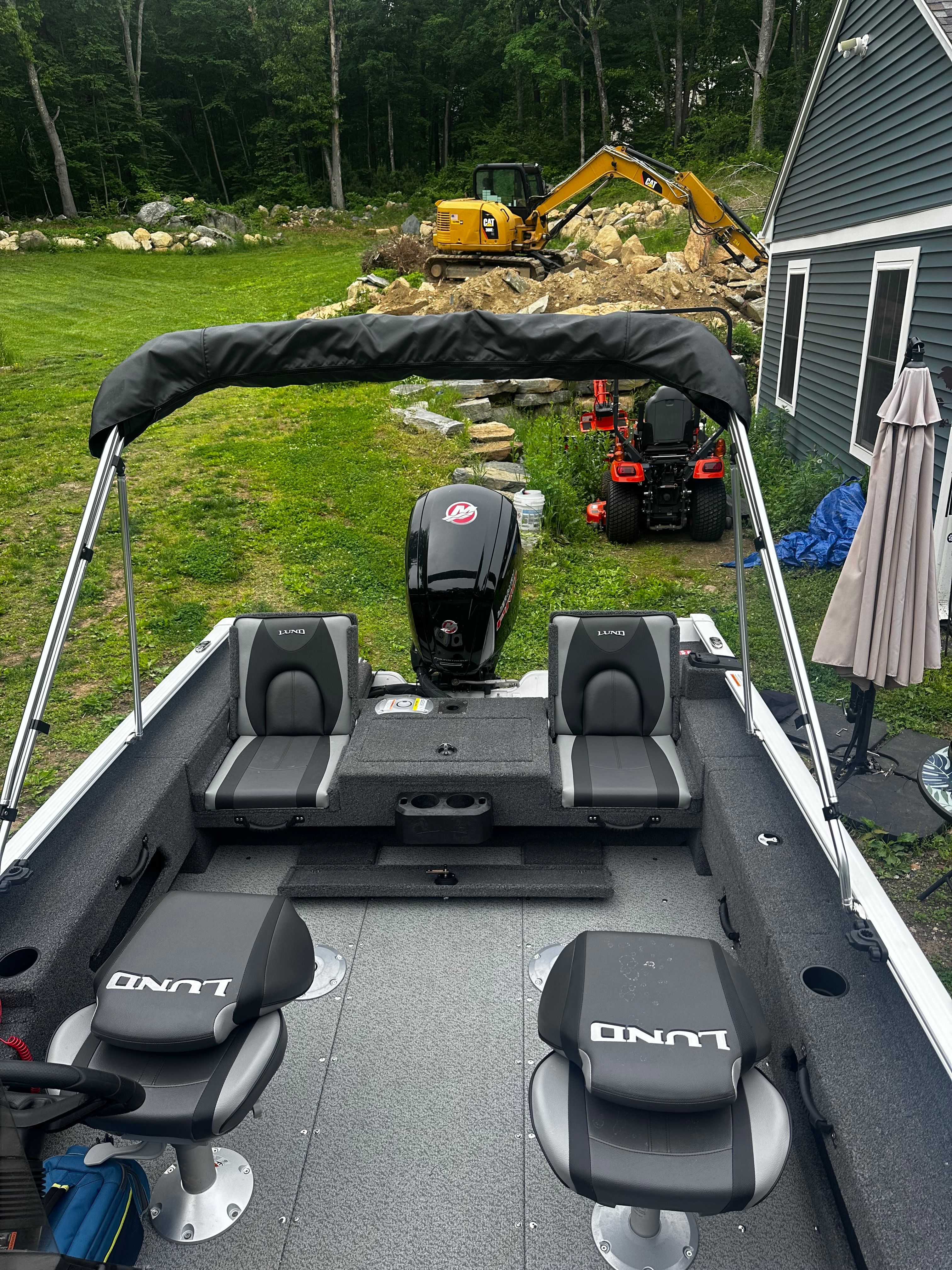 2025 Lund 1775 Adventure SS boat in backyard with excavator in background.